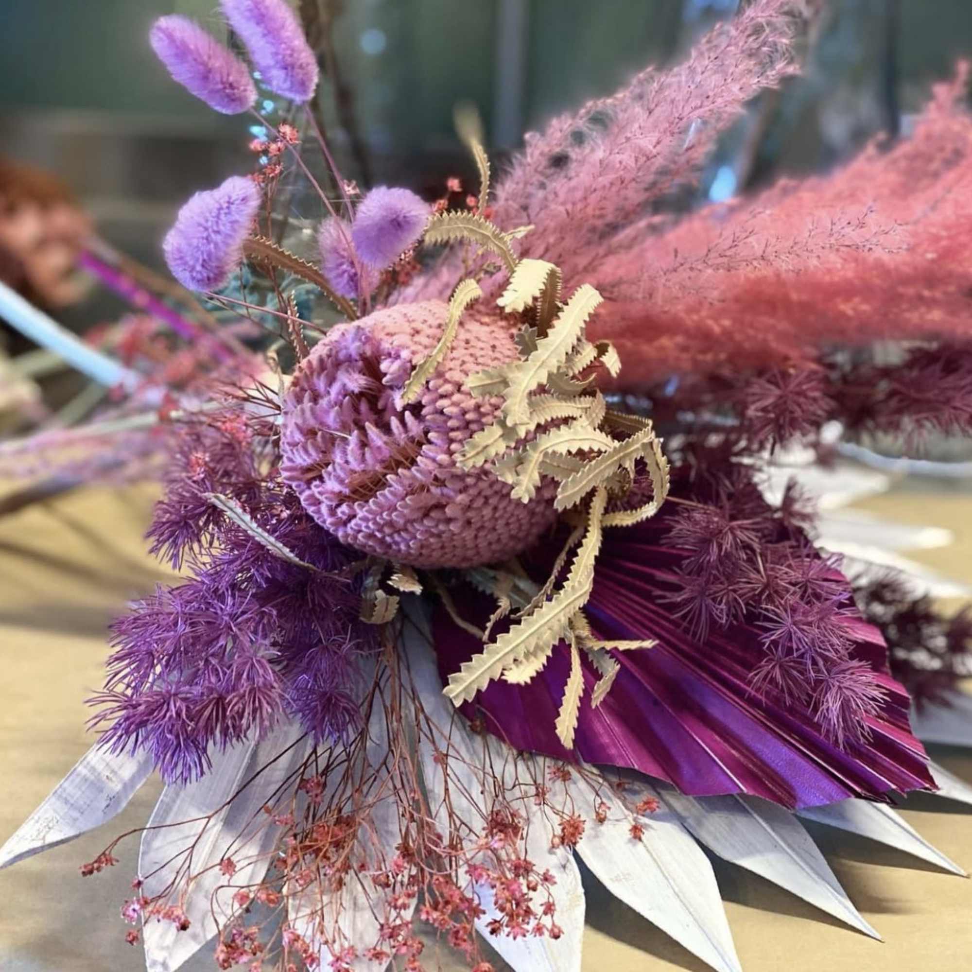 A colorful display of three #3 preserved floral bouquets 