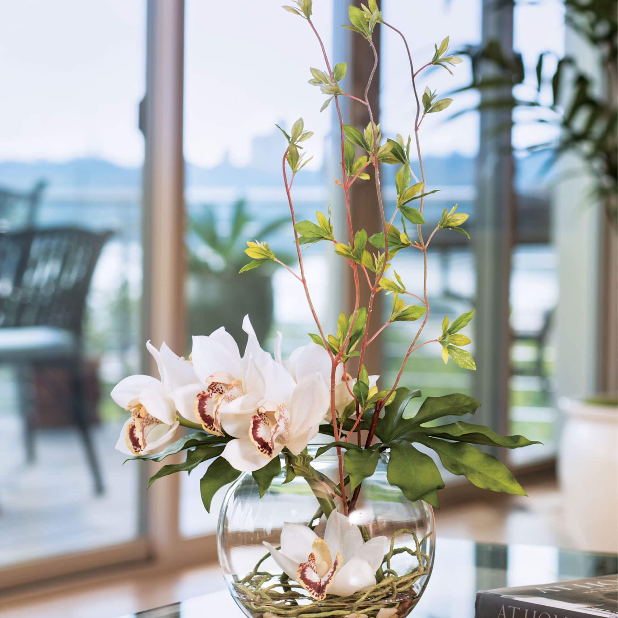 This forever centerpiece is full of silk blooms in a Zen style