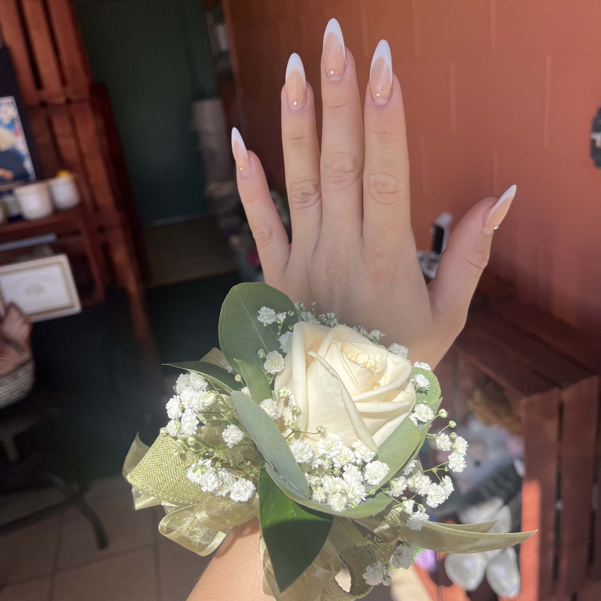 White rose wrist corsage with baby's breath and ribbon