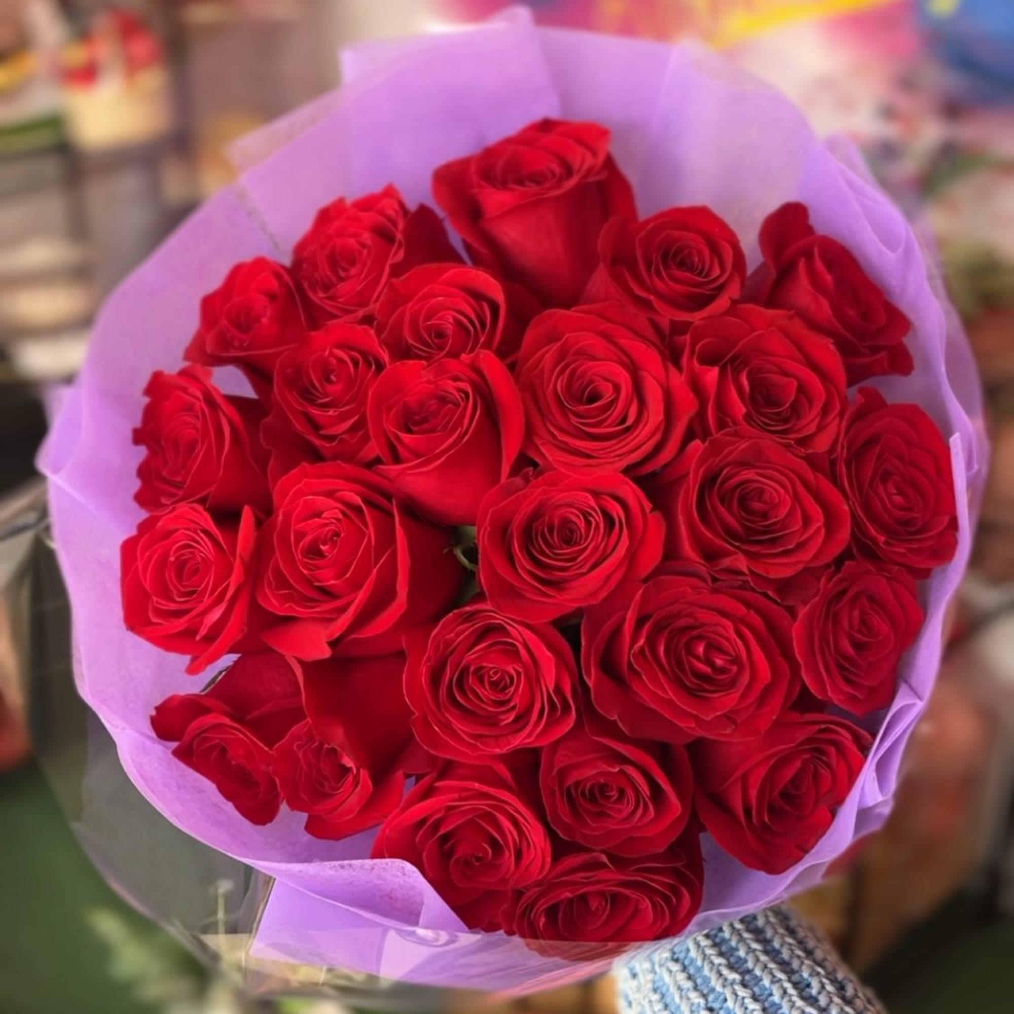 Bouquet of red roses wrapped in lavender paper