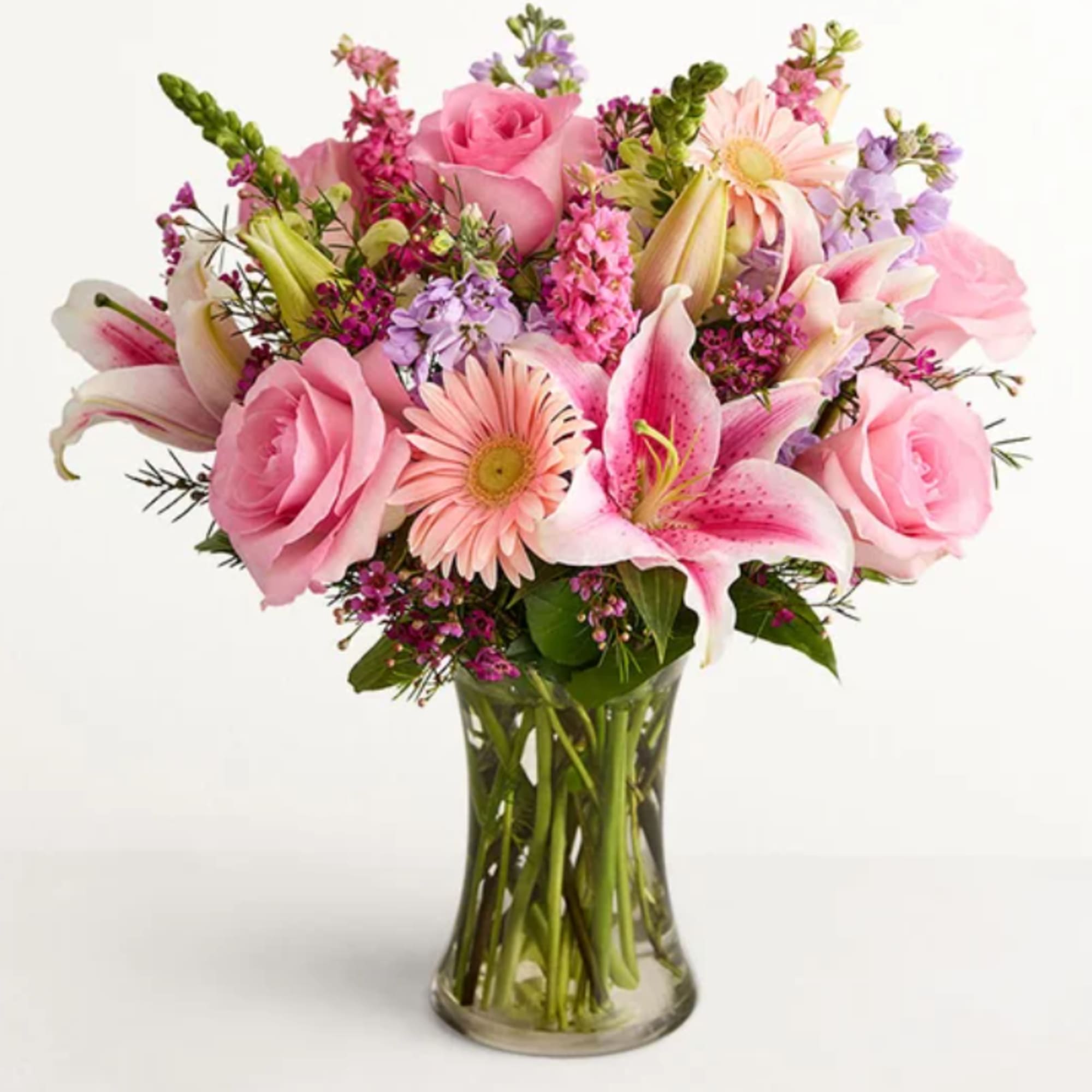 Soft pink roses and pink-and-white lilies mingle with pale peach gerbera and