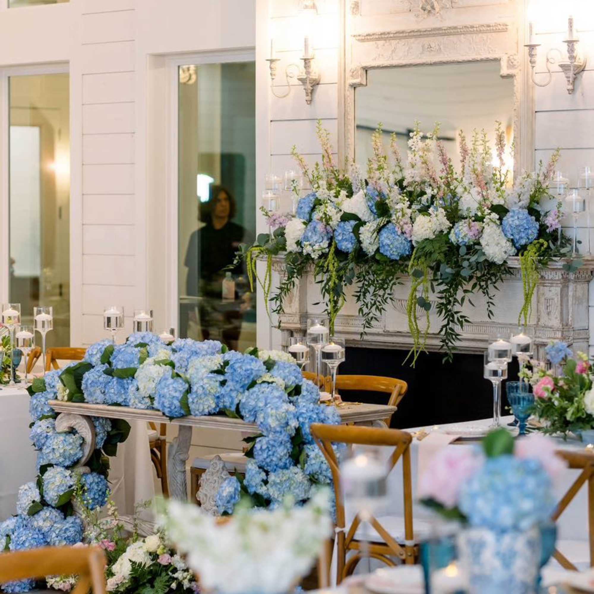 Blue and white floral centerpieces on decorated banquet tables