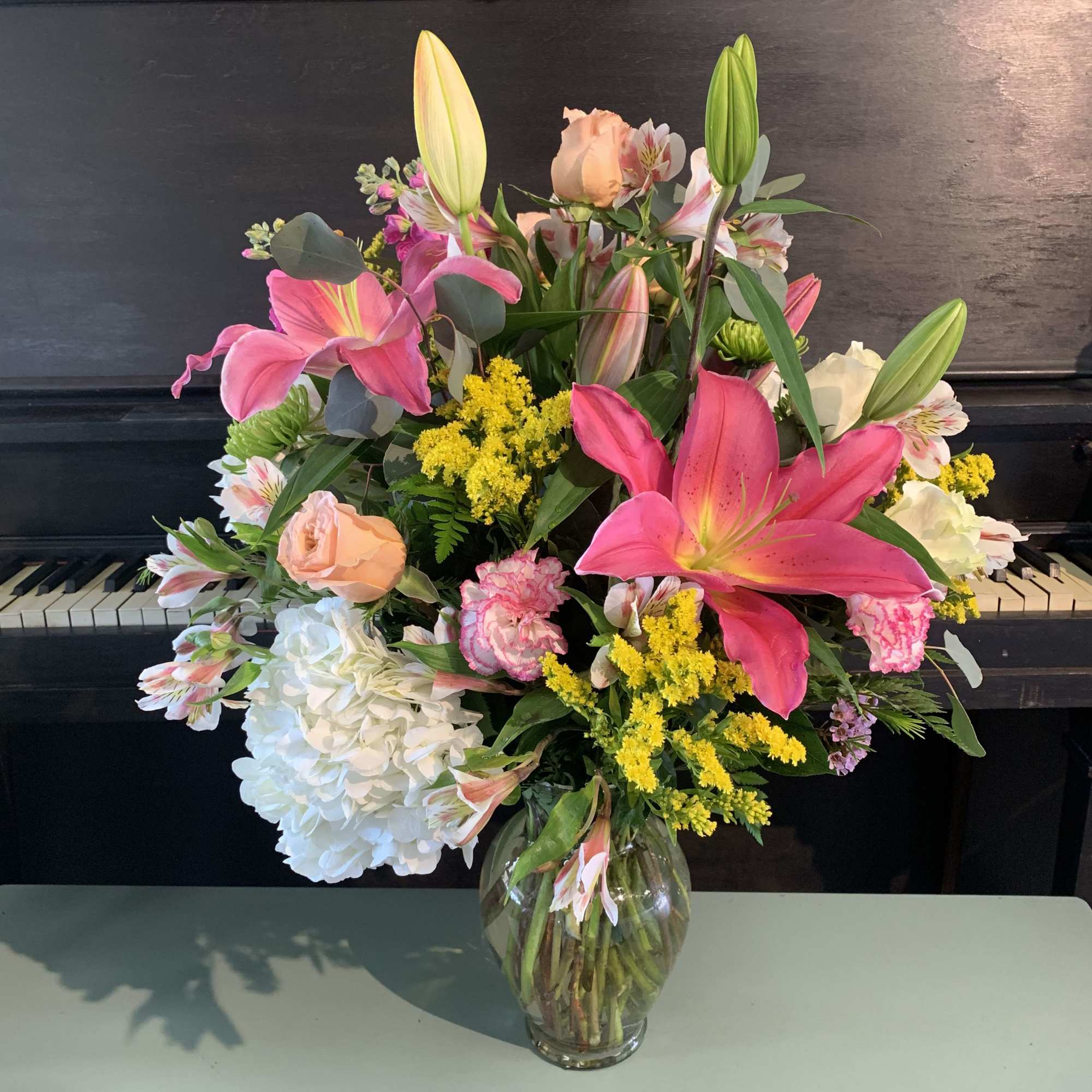A bright and colorful arrangement mixed with the freshest of flowers. These
