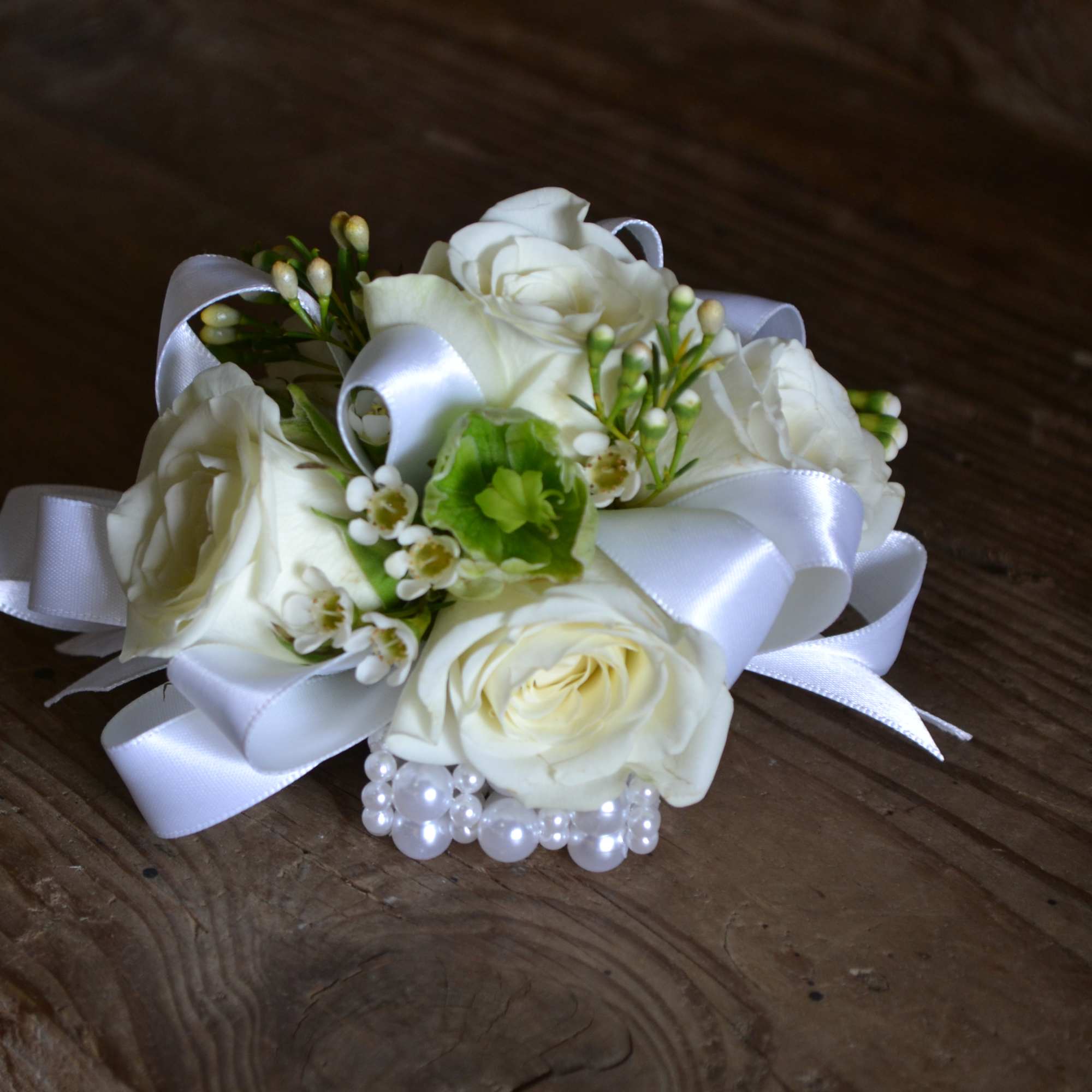 Ivory Pearl Wristlet Corsage with white spray roses, wax flower, and greens