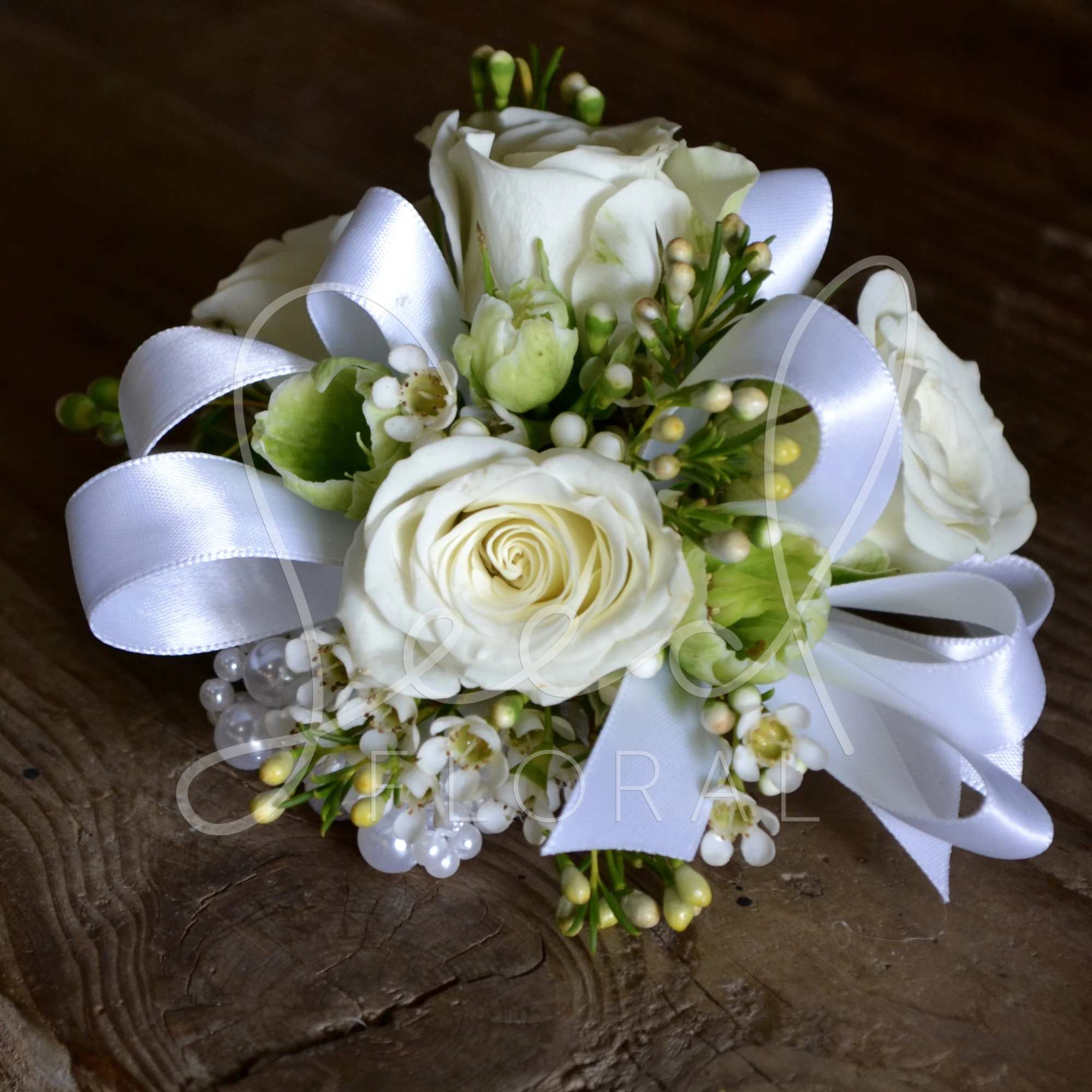 Ivory Pearl Wristlet Corsage with white spray roses, wax flower, and greens