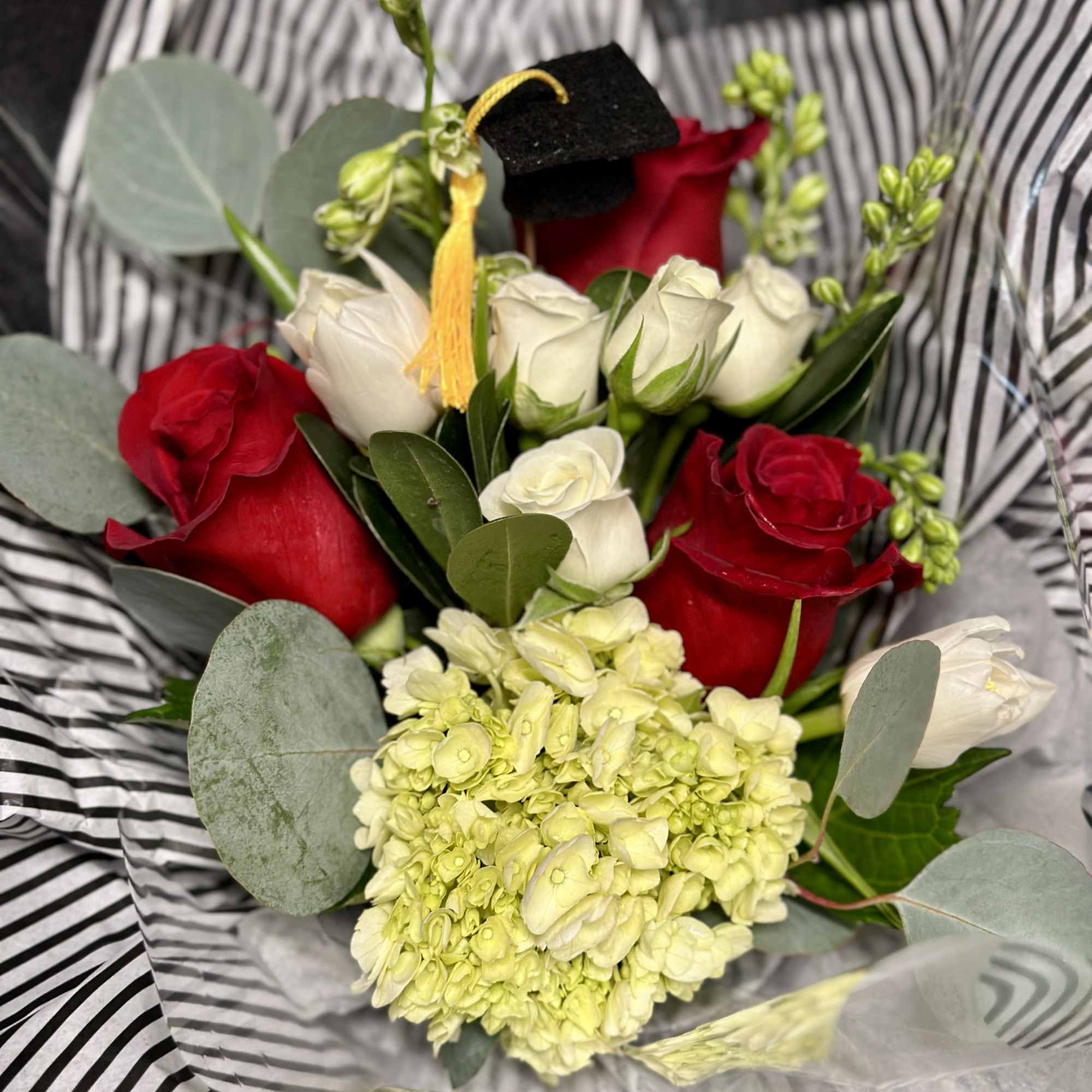 Celebrate your LT Grad with a pretty paper wrapped bouquet in Red