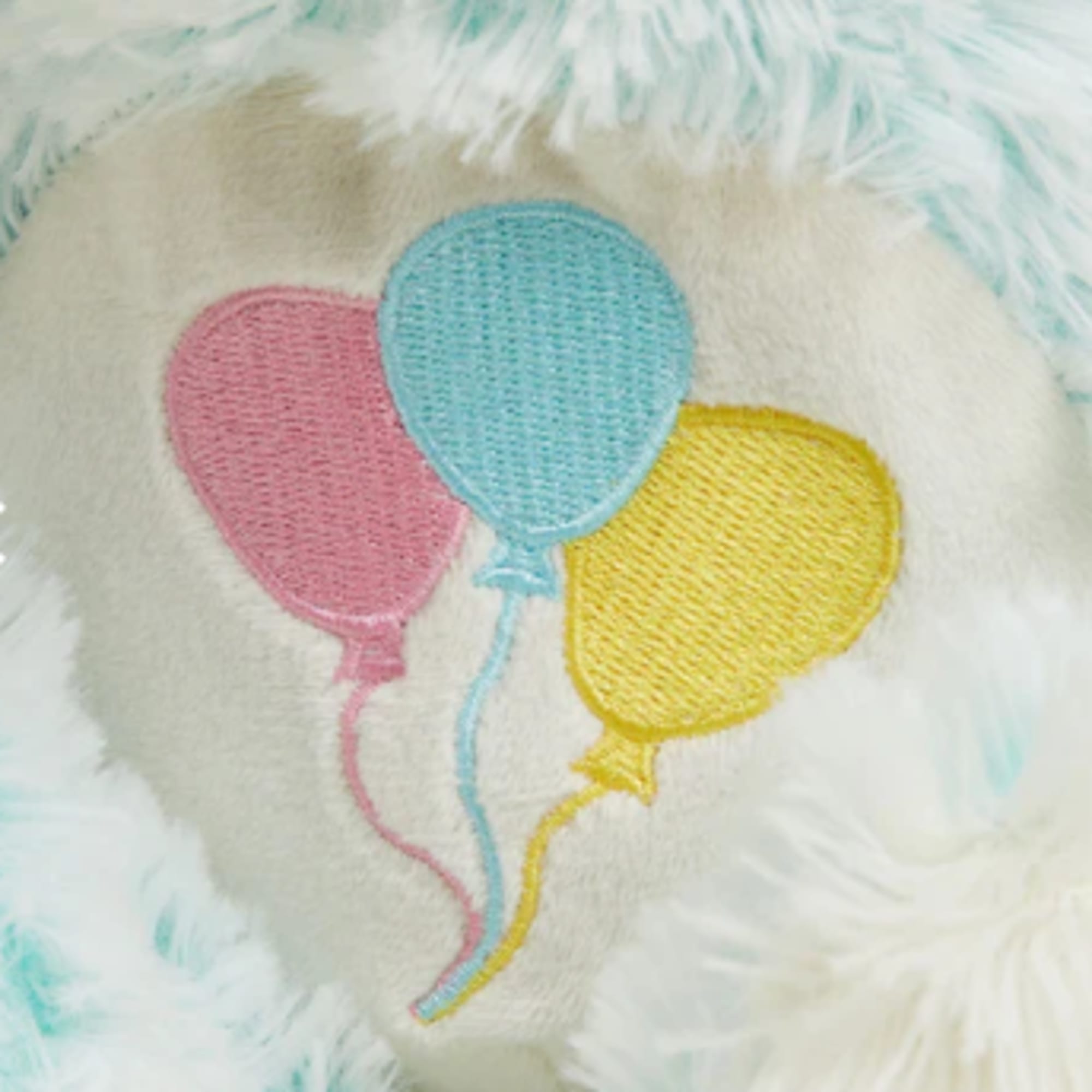 Plush toy with embroidered pink, blue, and yellow balloons
