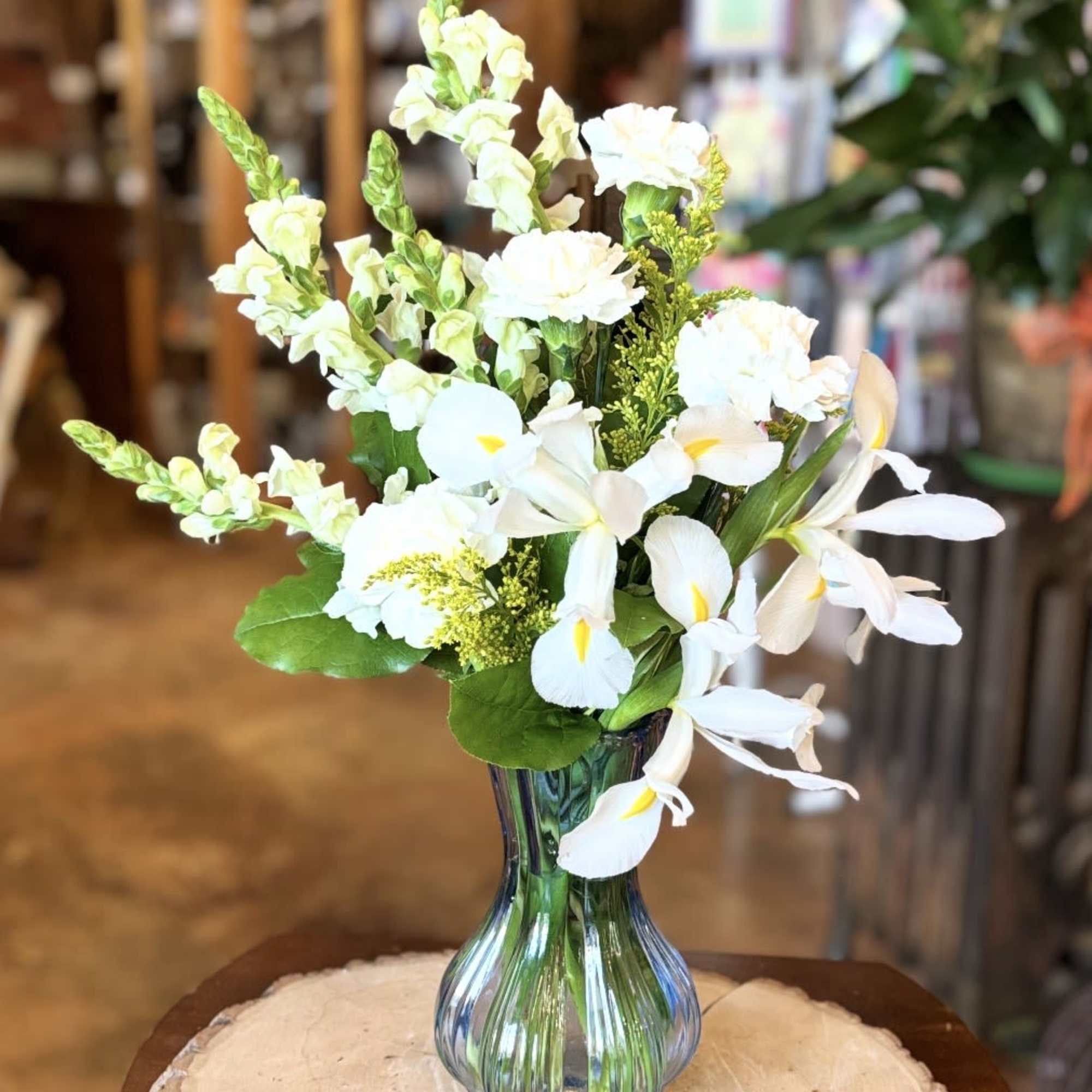 White flowers arranged in a blue glass vase