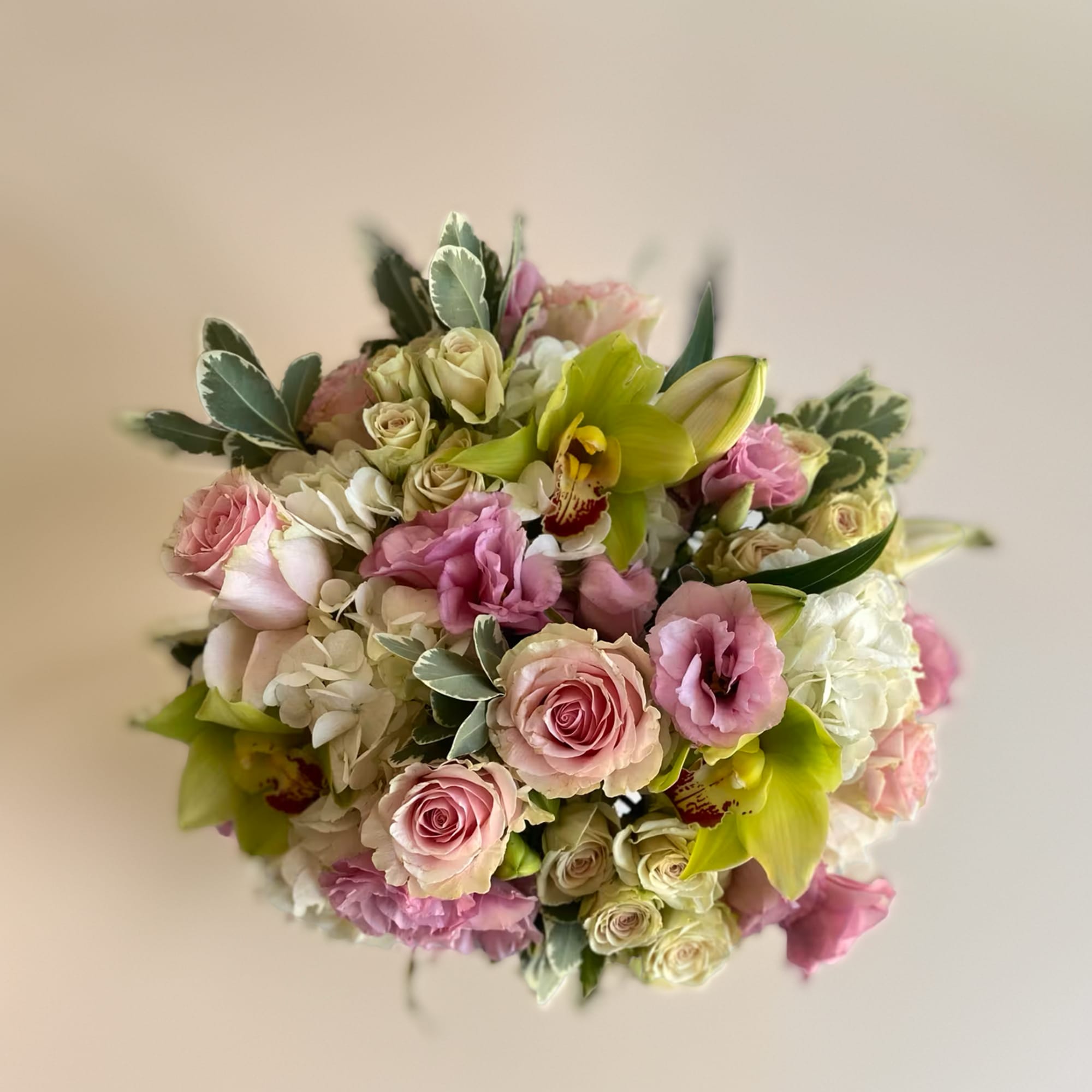 Bouquet of pink roses, white hydrangea, and green orchids