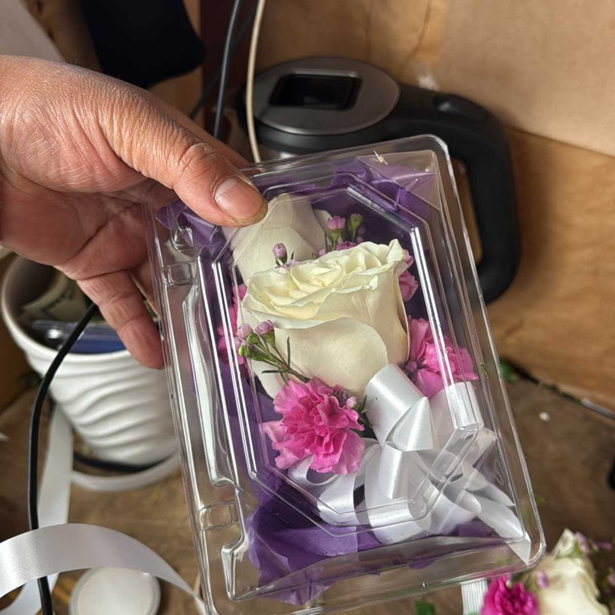 Elegant graduation corsage designed with high-quality fresh flowers. Colors and style will