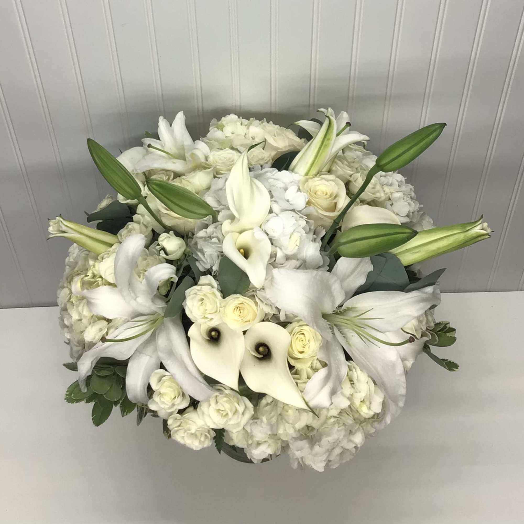 A whisper-quiet affirmation of love. Subtle shadings of  white roses lilies