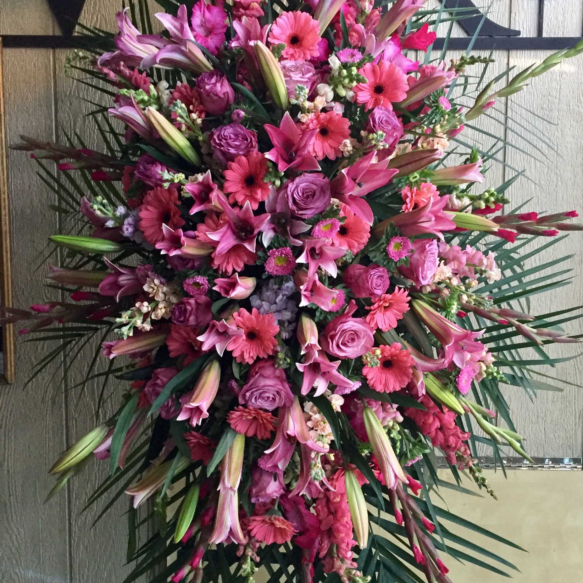 Large pink and purple floral spray with lilies and roses