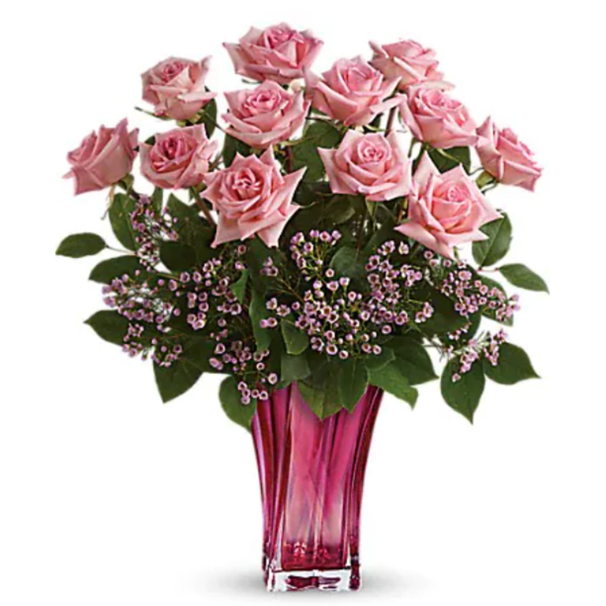 Pink roses arranged in a tall glass vase with small purple filler flowers