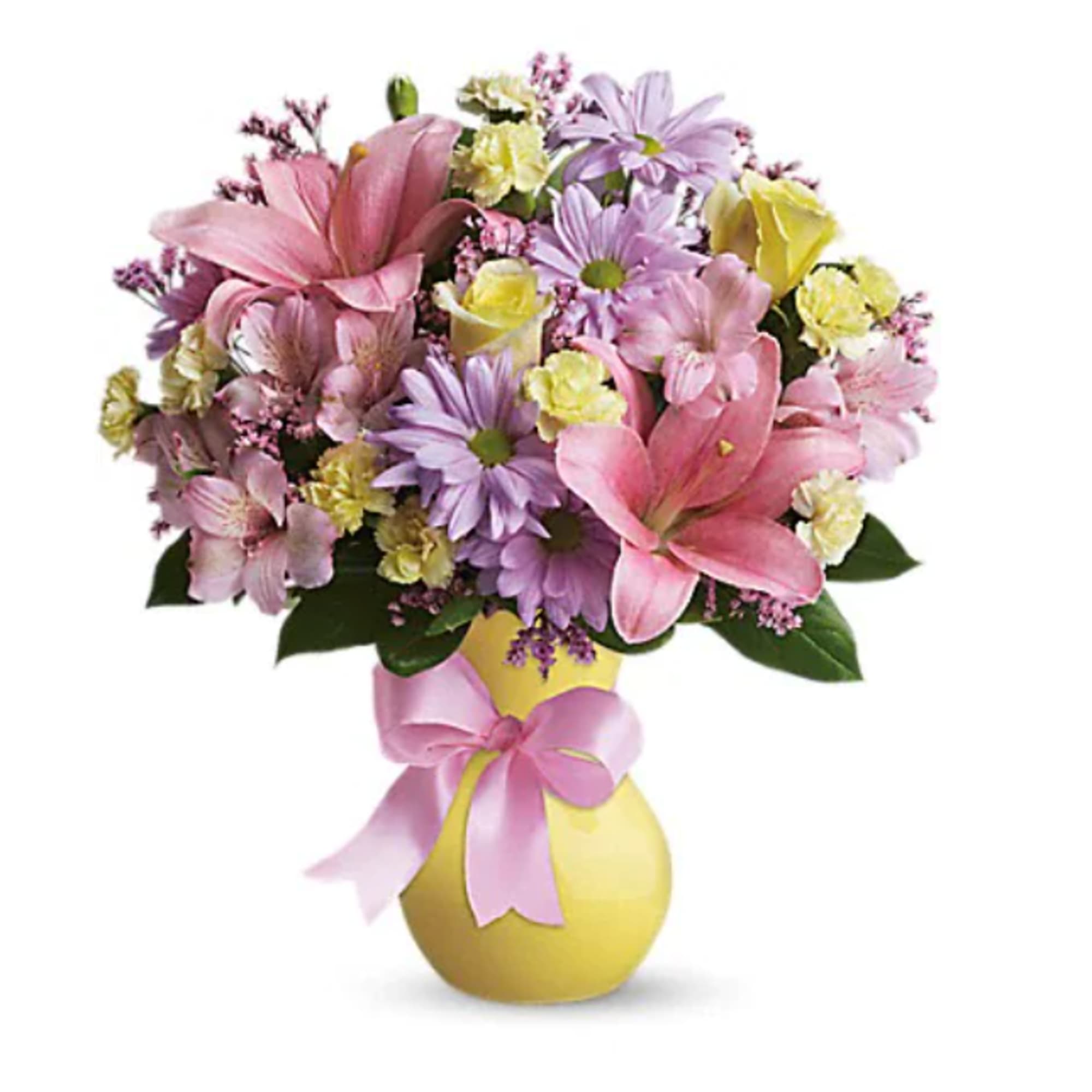 Pink and lavender mixed bouquet in a yellow vase with a pink ribbon
