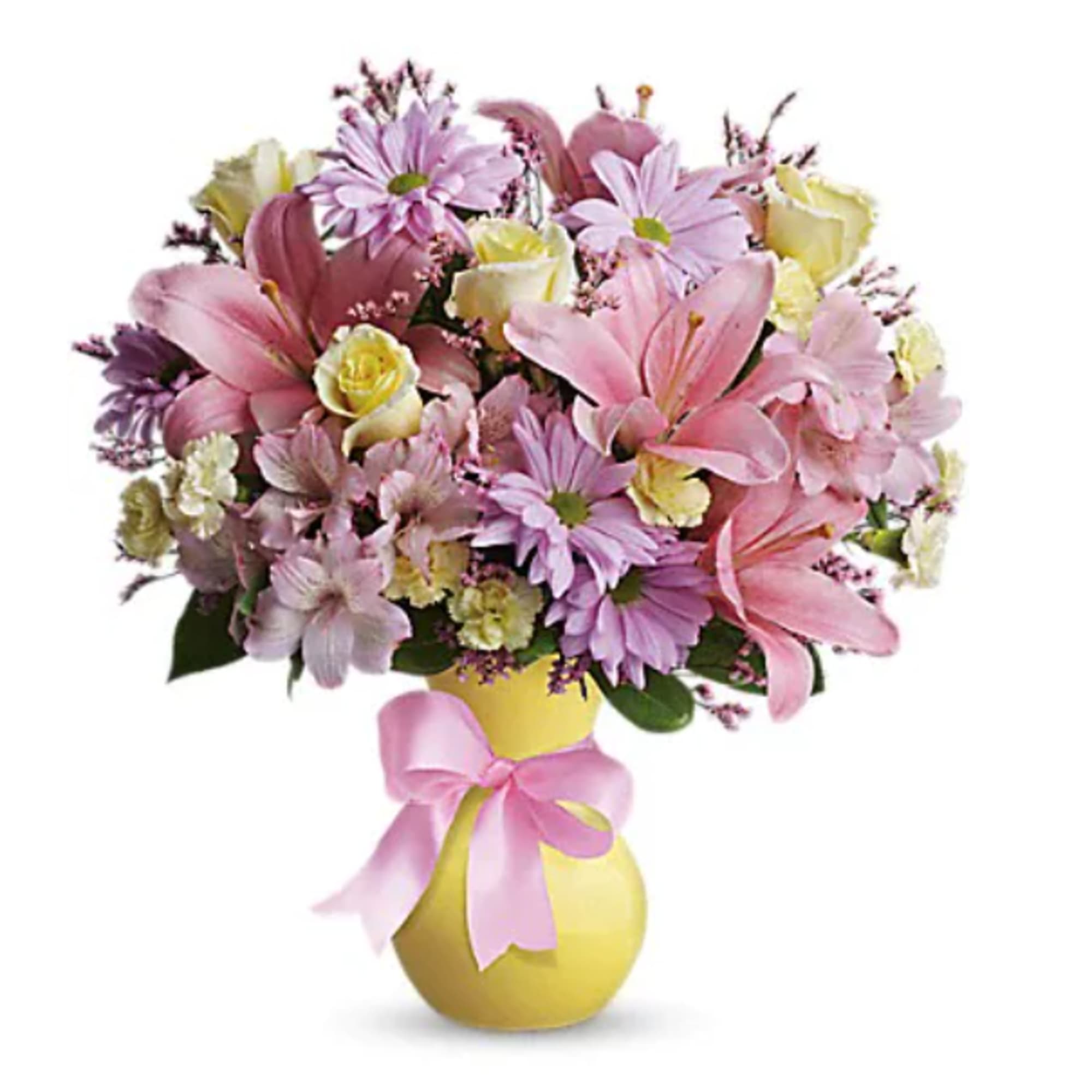 Pink and lavender bouquet with lilies and daisies in a yellow vase with a pink ribbon