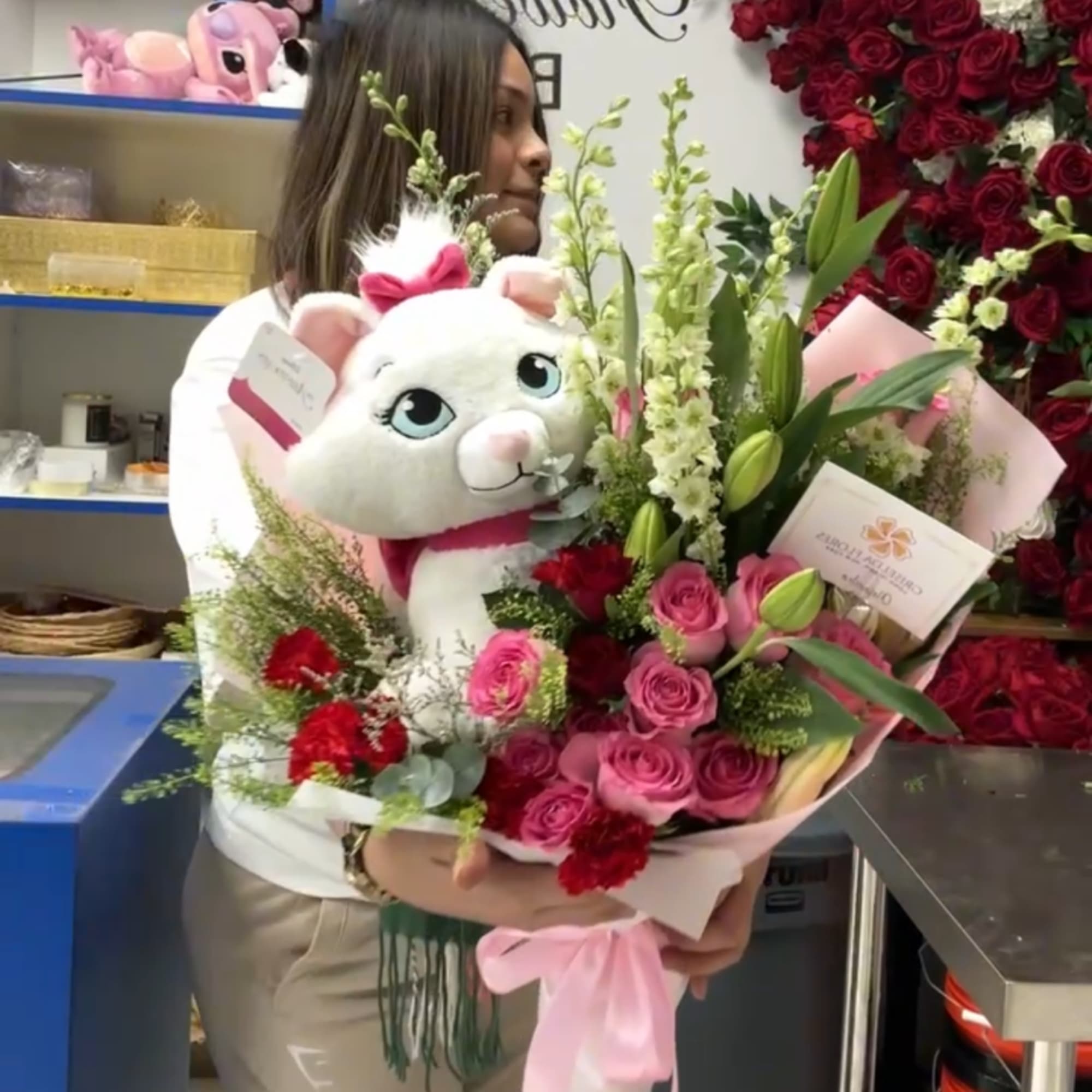 Bouquet of pink roses and lilies with a plush white teddy bear