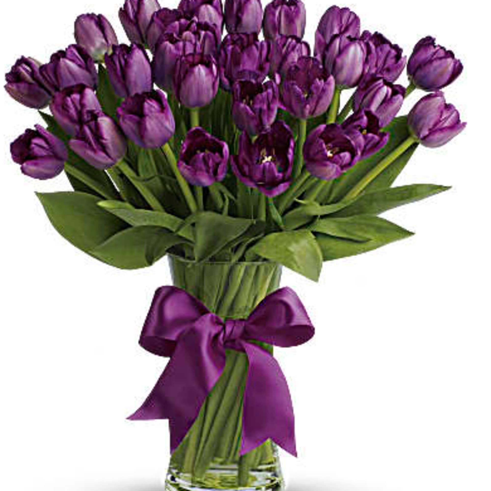 Purple tulip bouquet in a clear glass vase with a purple ribbon