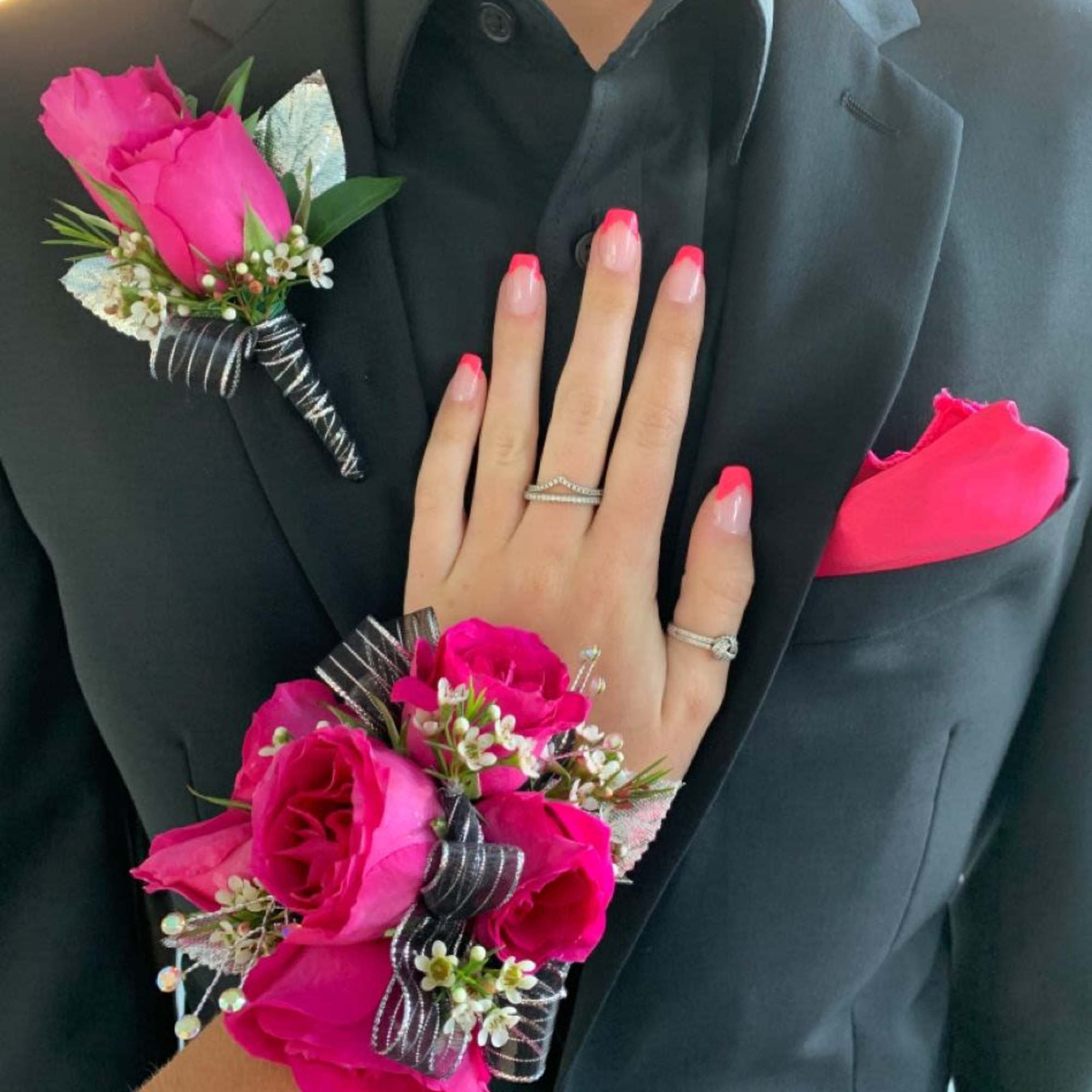 A hot pink rose boutonniere and matching wrist corsage set that makes