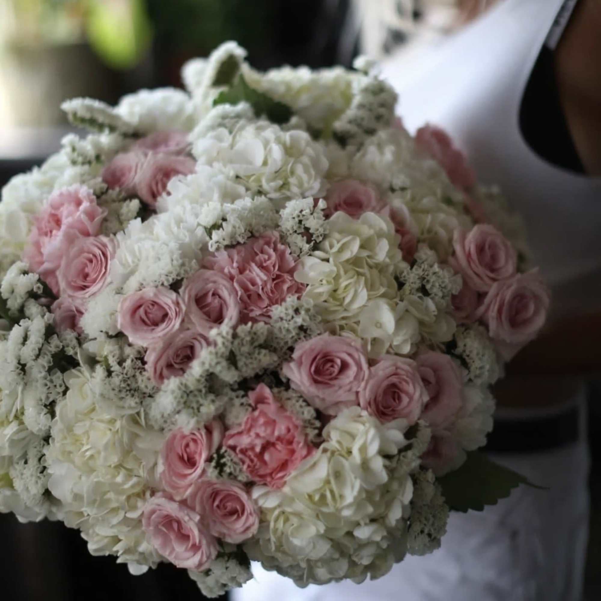 A soft and elegant bouquet designed with blush pink roses, spray roses