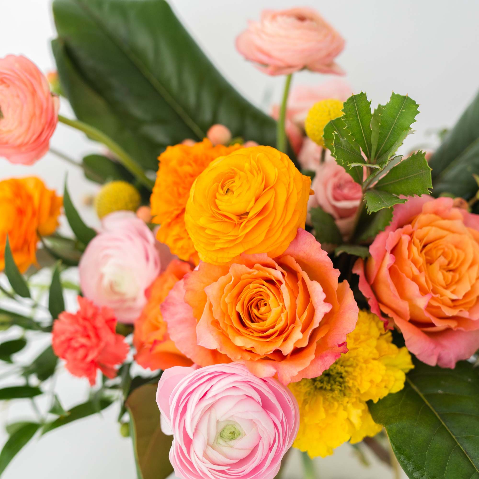 Bouquet of orange, pink, and yellow flowers in a vase