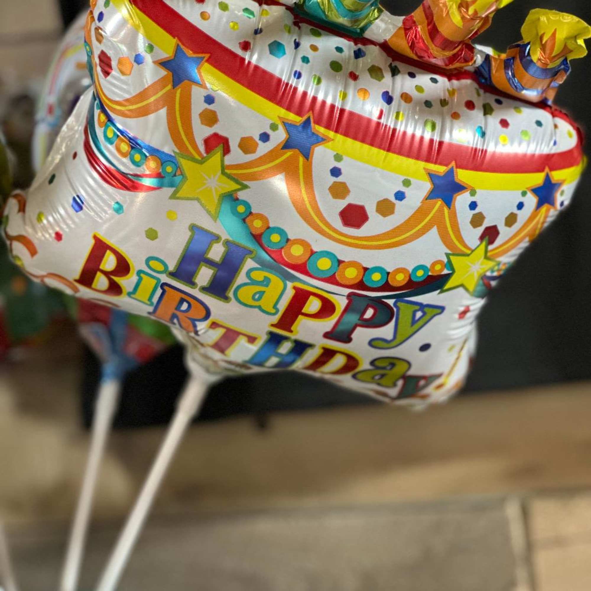 Birthday balloon with colorful confetti and star graphics