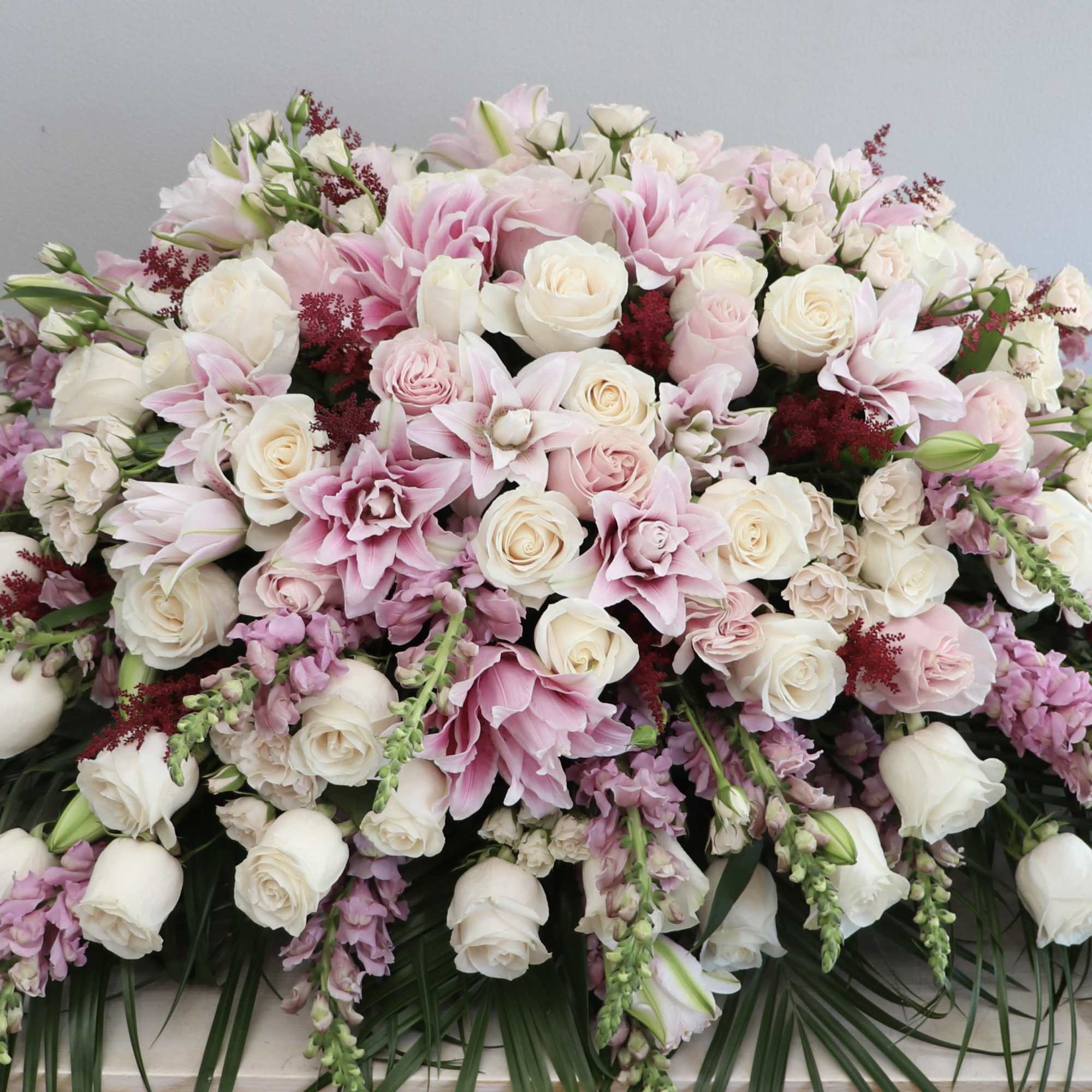 Large pink and white floral arrangement with roses and lilies
