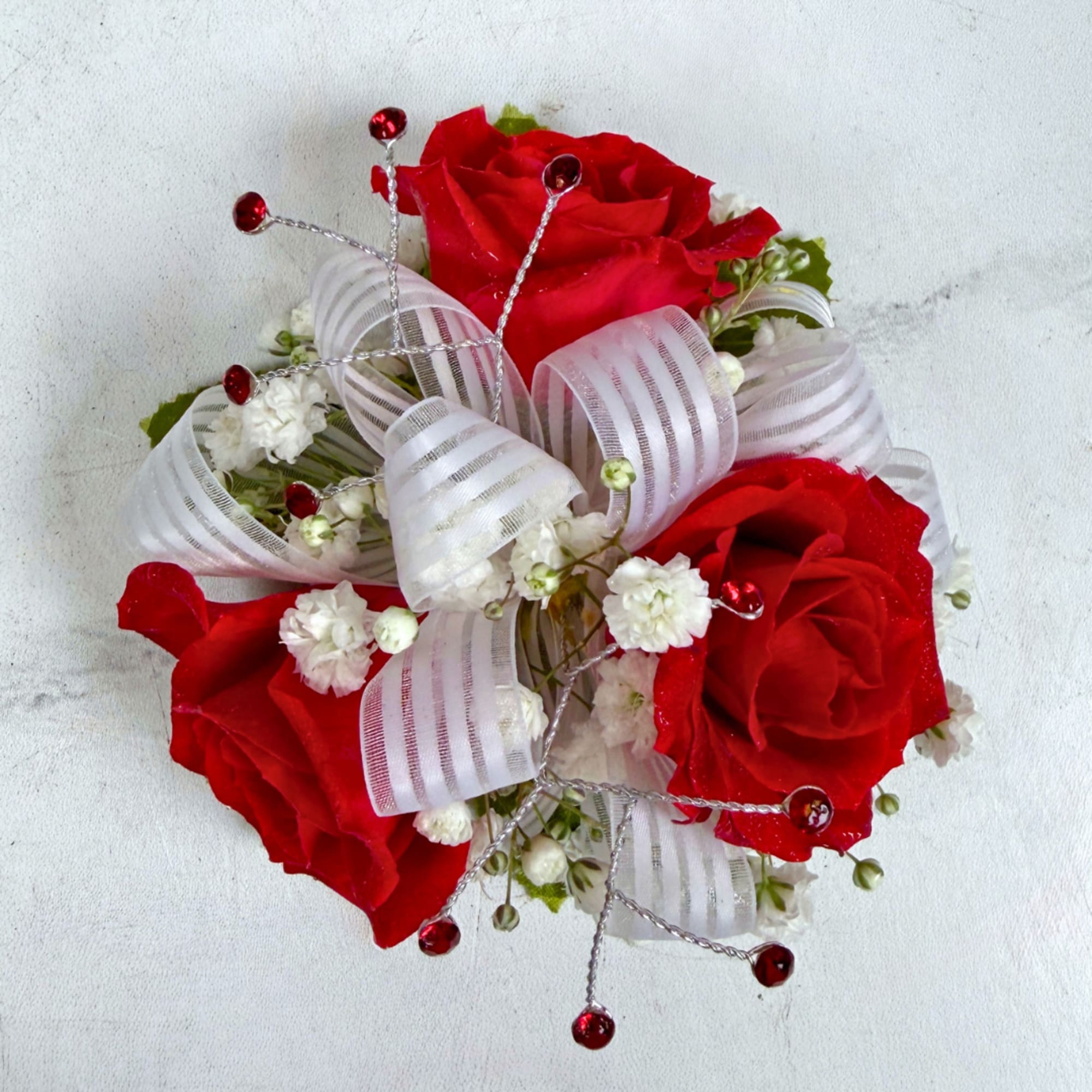 3 petite, classy red spray roses form a delicate, wearable cluster in
