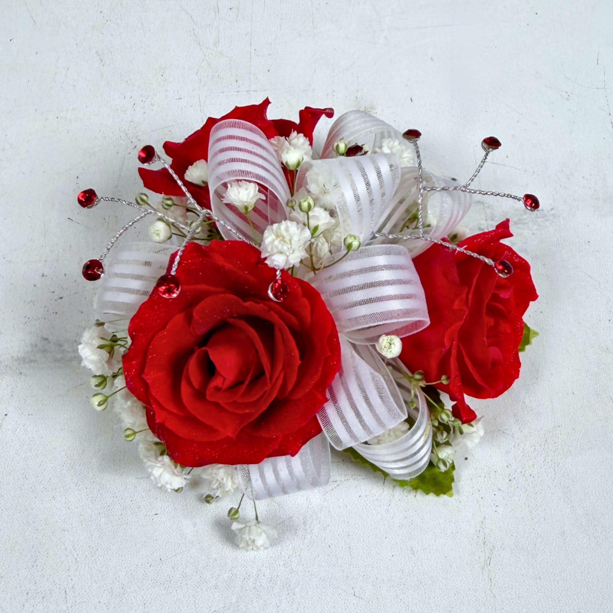 3 petite, classy red spray roses form a delicate, wearable cluster in