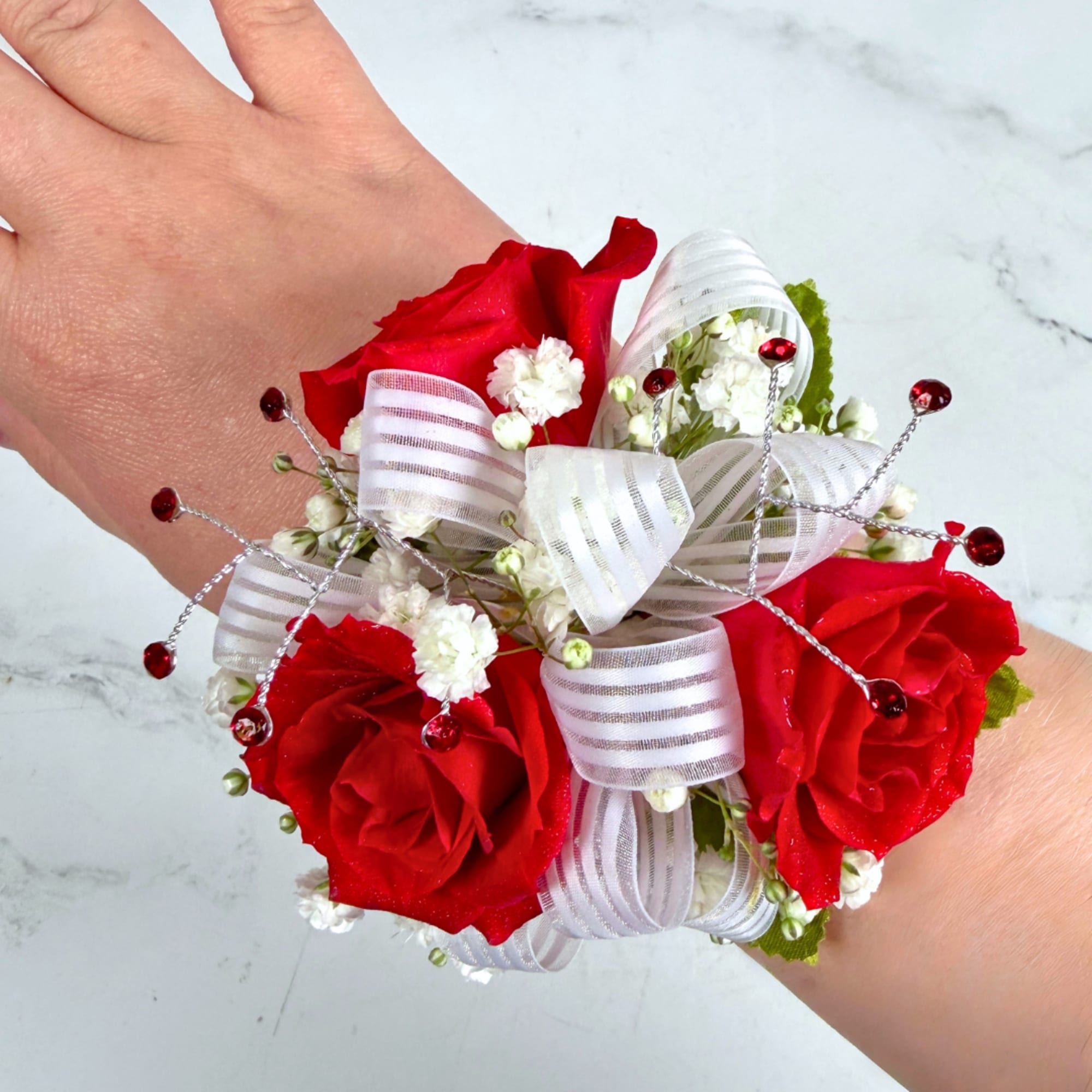 3 petite, classy red spray roses form a delicate, wearable cluster in