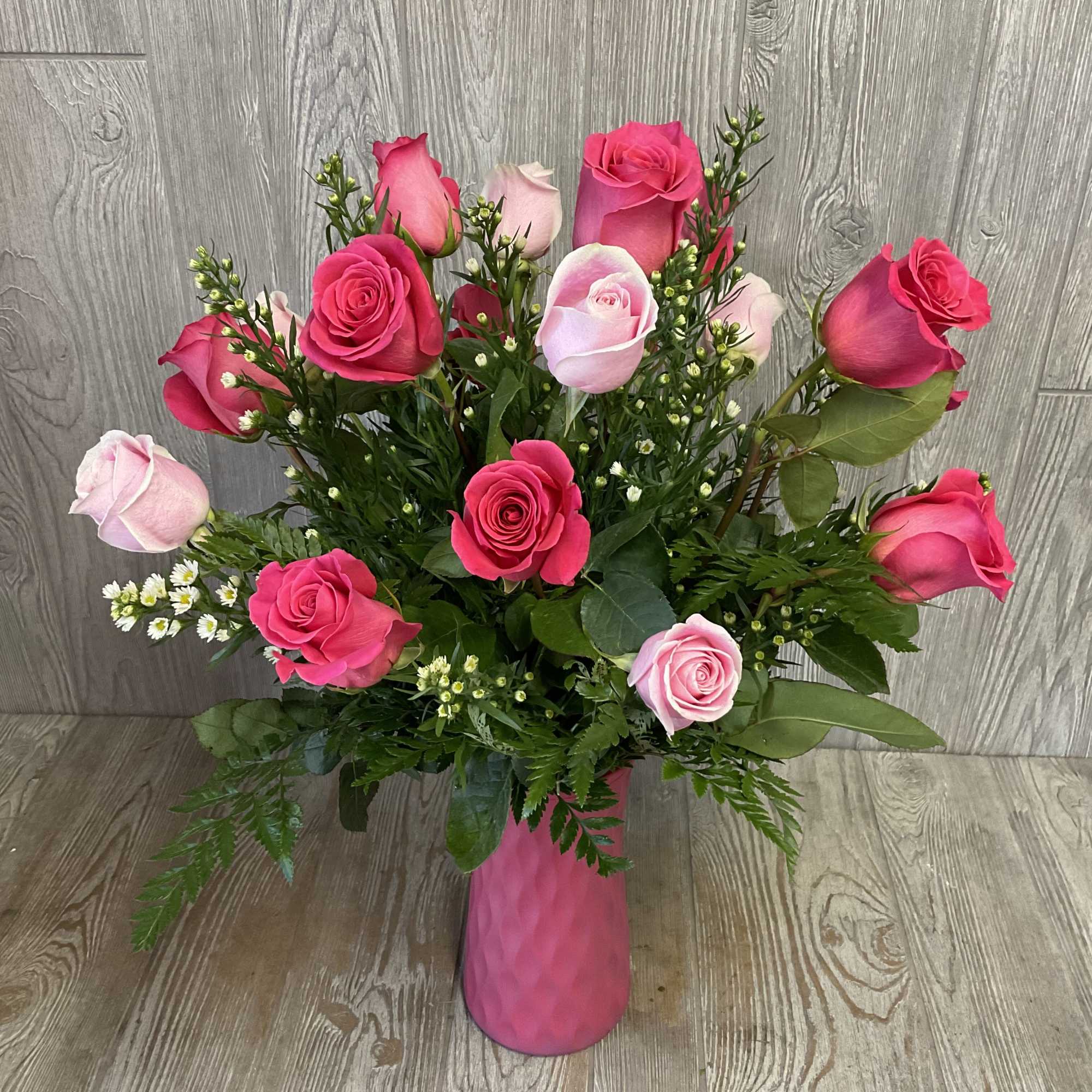 Pink and light pink roses in a pink vase