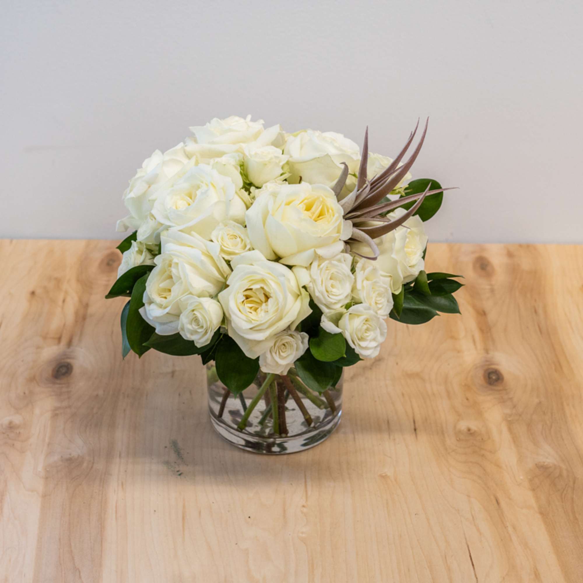 White rose bouquet in a clear glass vase