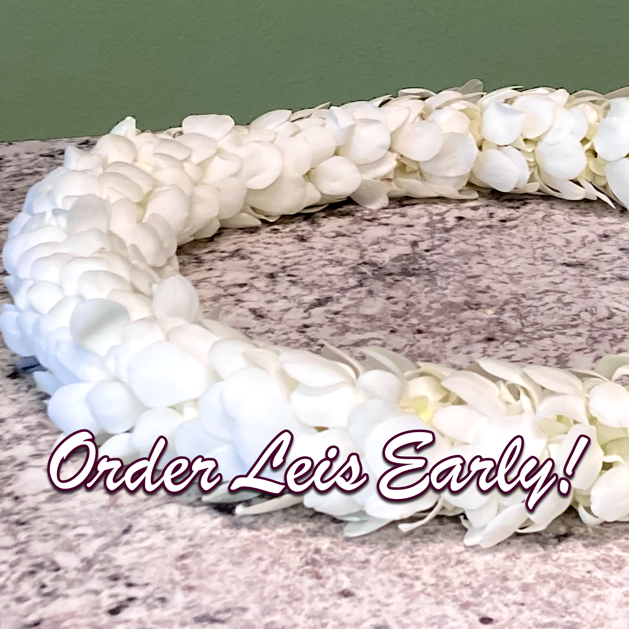 White lei made of layered petals on a stone surface