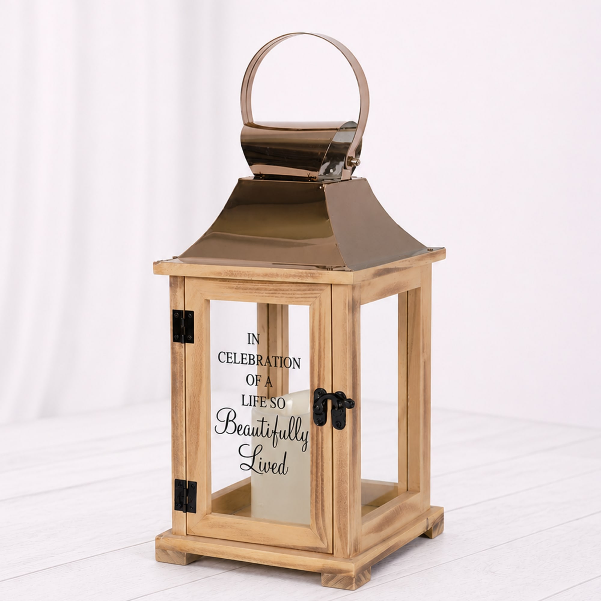 A cream candle in a rustic wooden lantern with copper top and