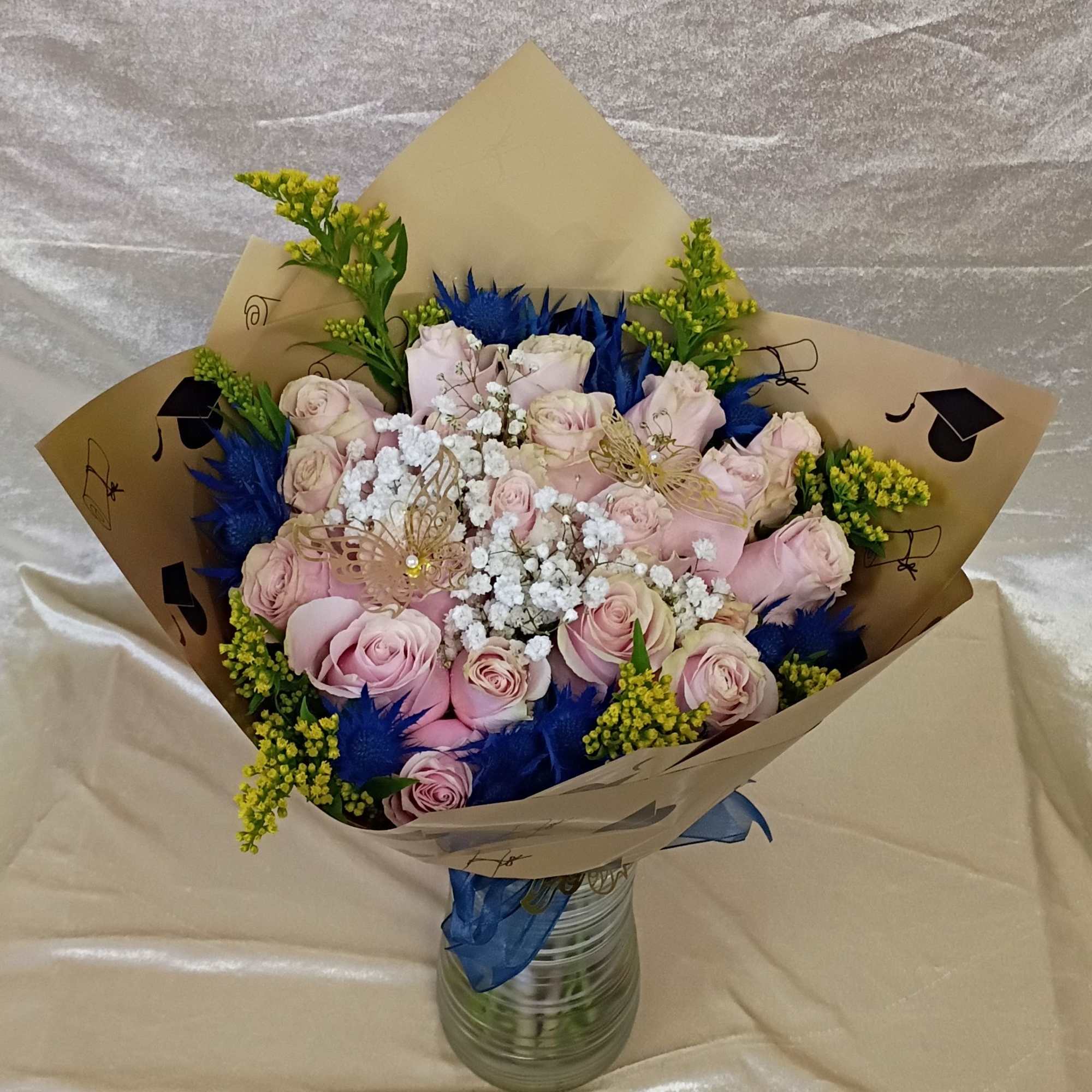 Pale pink roses gather in a soft, romantic cluster centered on a