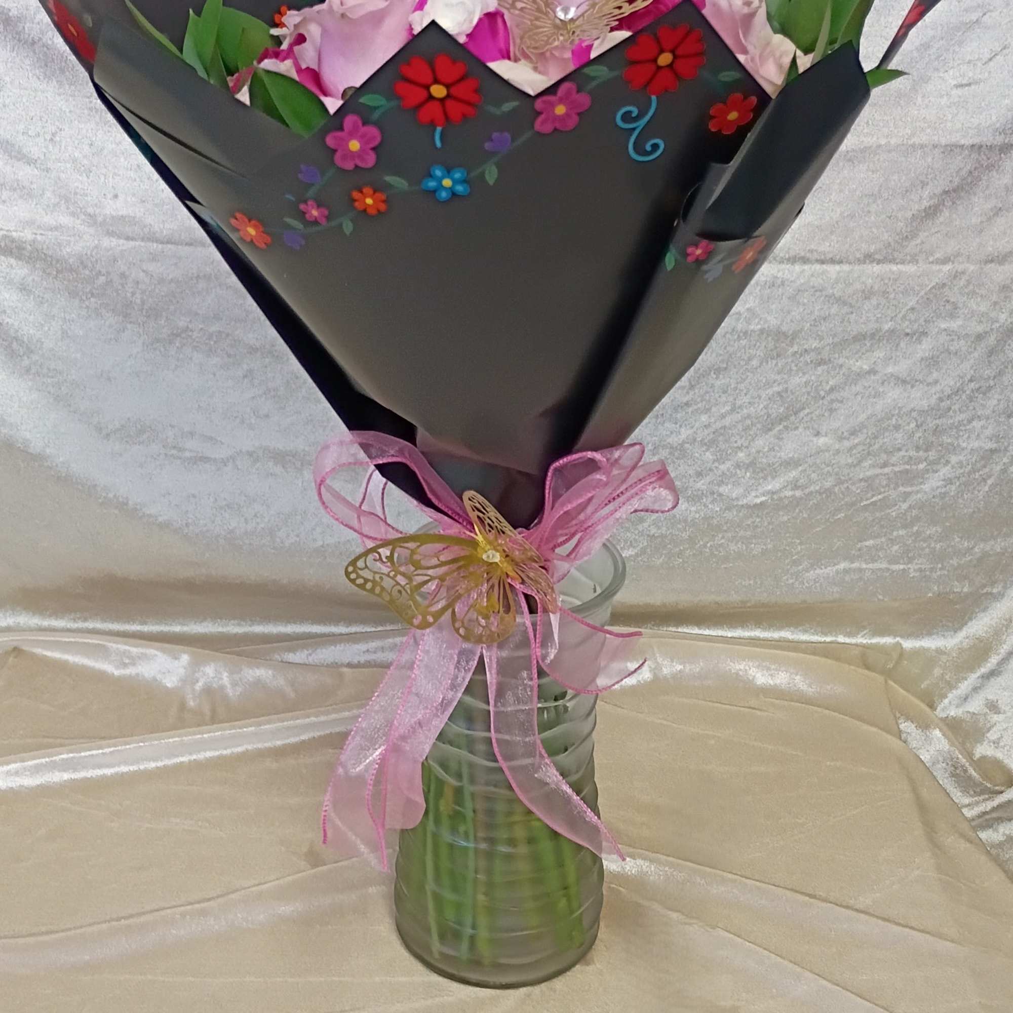 A tightly packed spray of two dozen pink roses creates an immediate