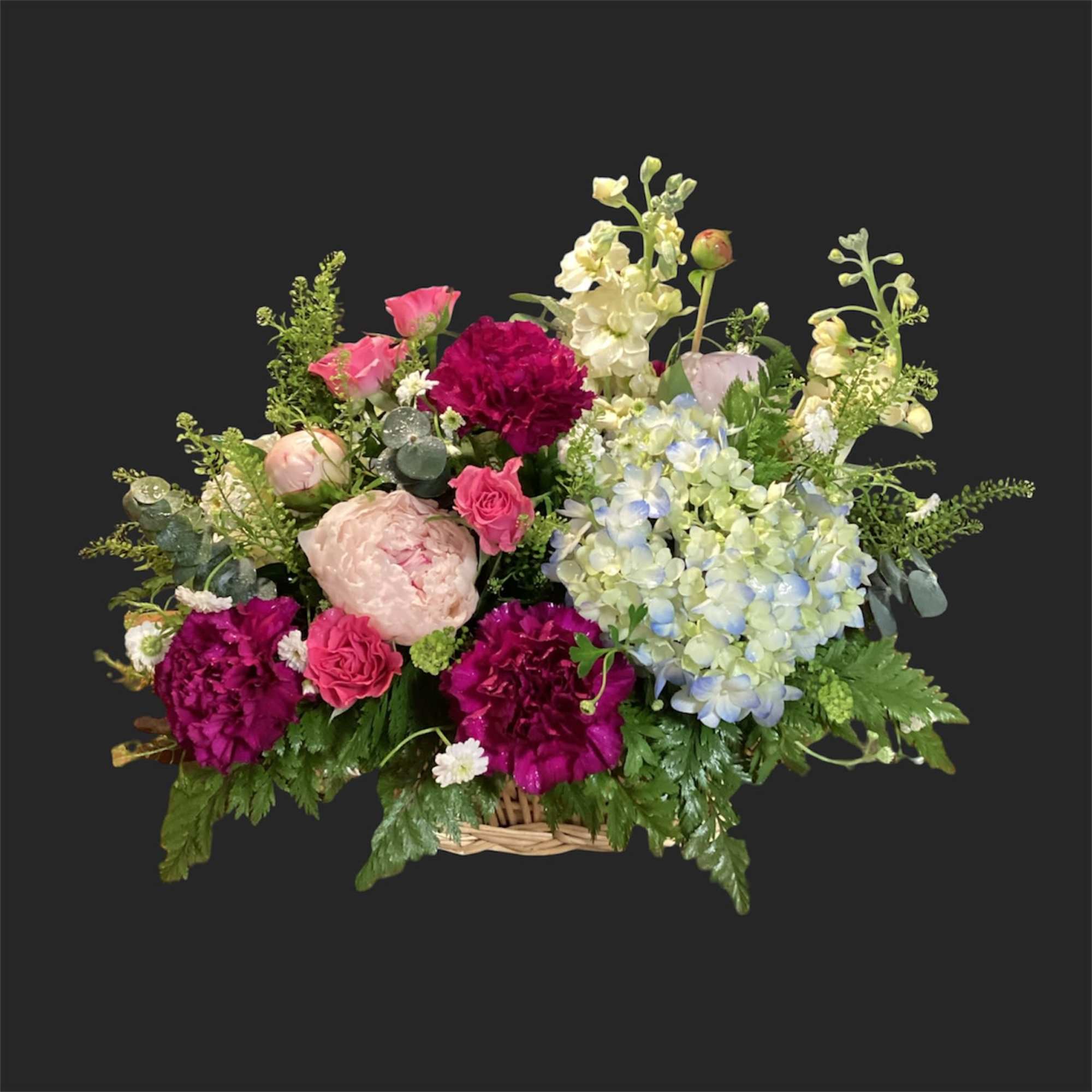Pink lilies arching above a rounded teacup vase set the tone for
