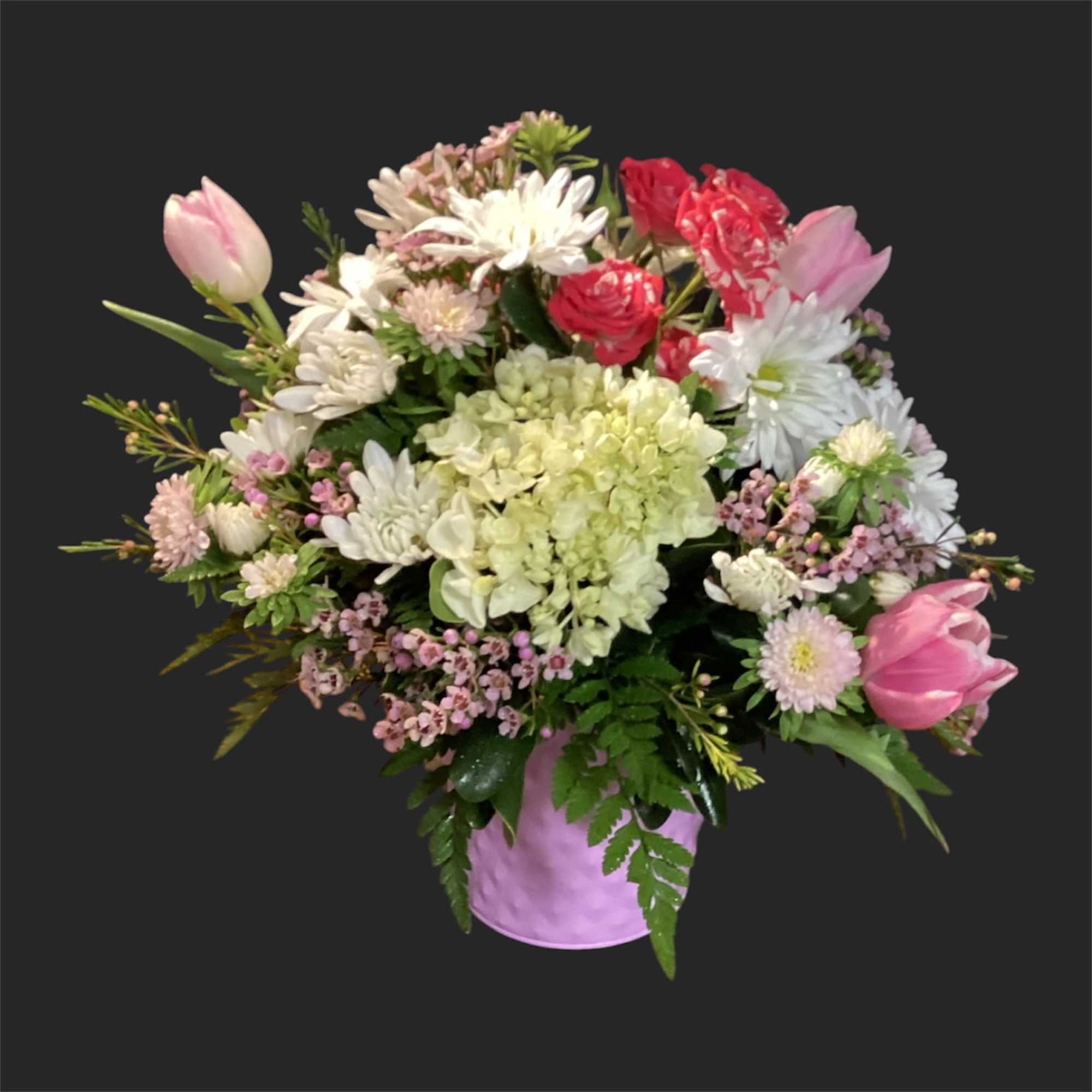 Pink lilies arching above a rounded teacup vase set the tone for