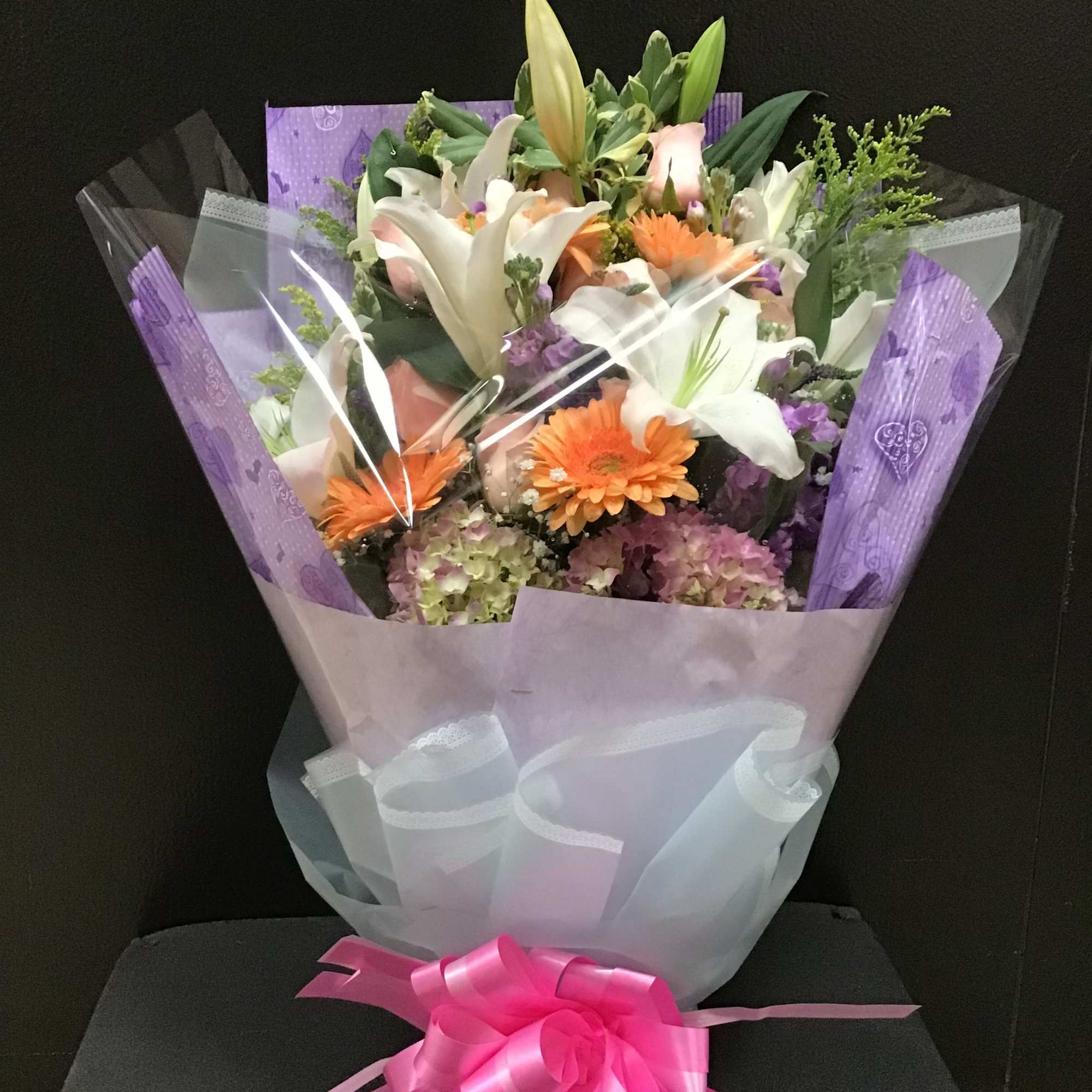 This bouquet make white lilies, pink roses, peach gerbera daisy and hydrangea