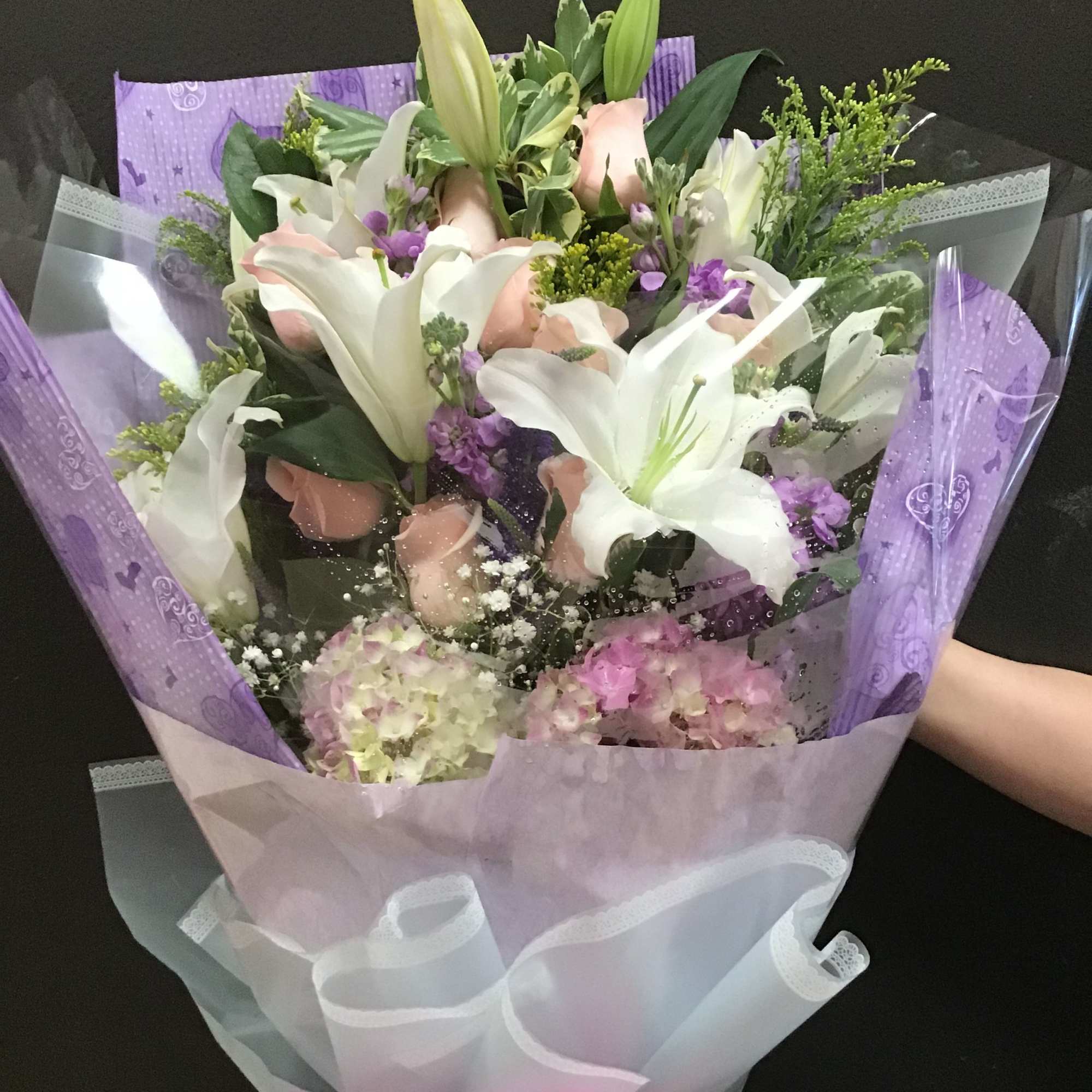 This bouquet make white lilies, pink roses, peach gerbera daisy and hydrangea