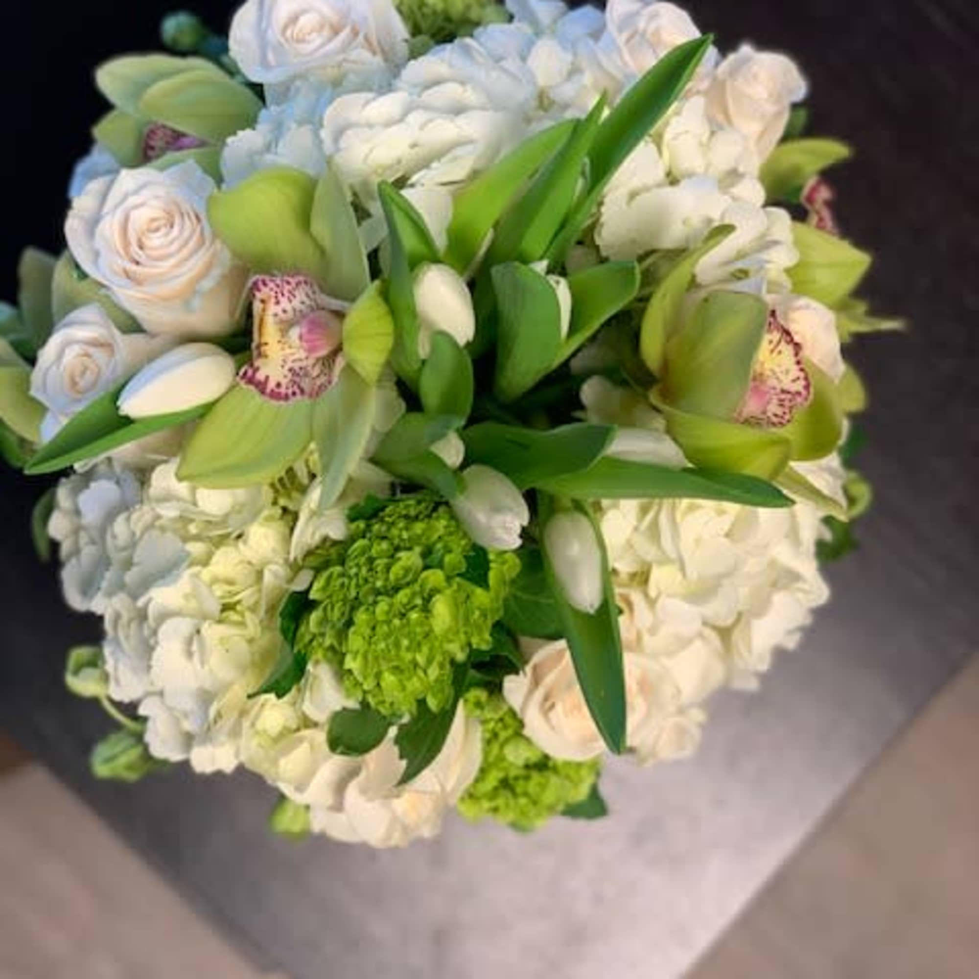 Bouquet of white and pale blue flowers with green orchids
