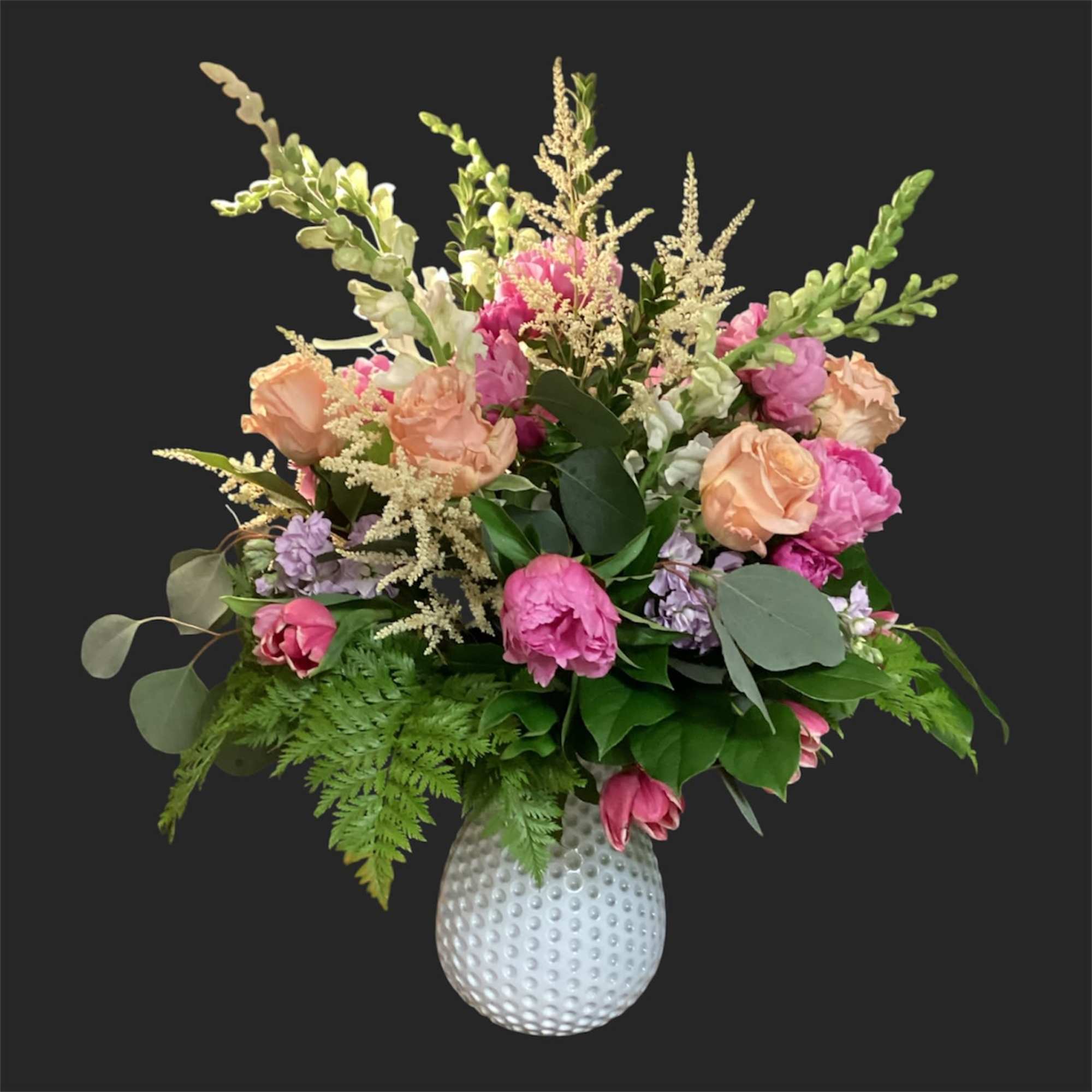 A lively, ever-changing bouquet that surprises with garden-fresh personality-this designer's choice exquisite