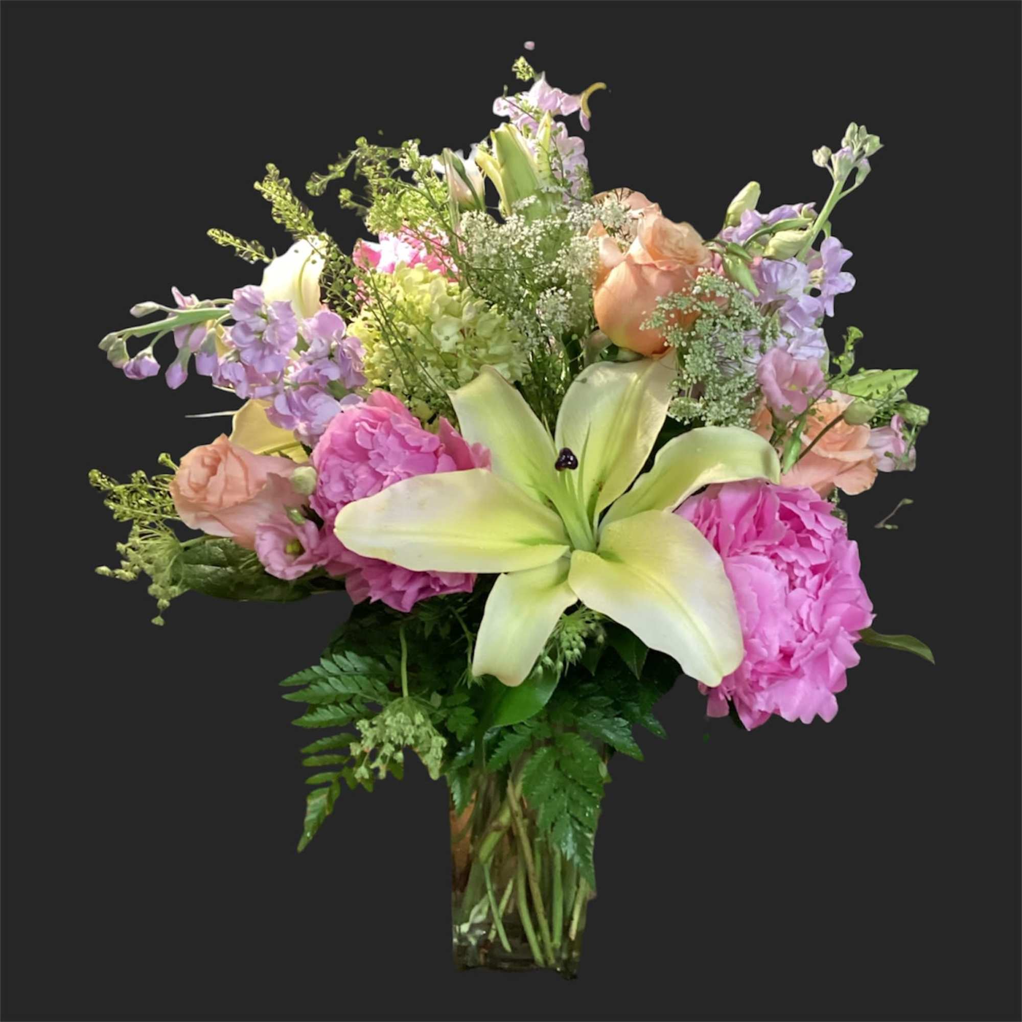 A lively, ever-changing bouquet that surprises with garden-fresh personality-this designer's choice exquisite