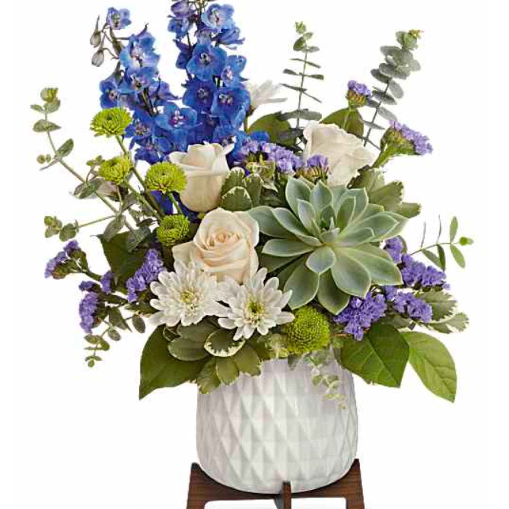 Tall blue delphinium spikes rise above a soft cloud of white daisies