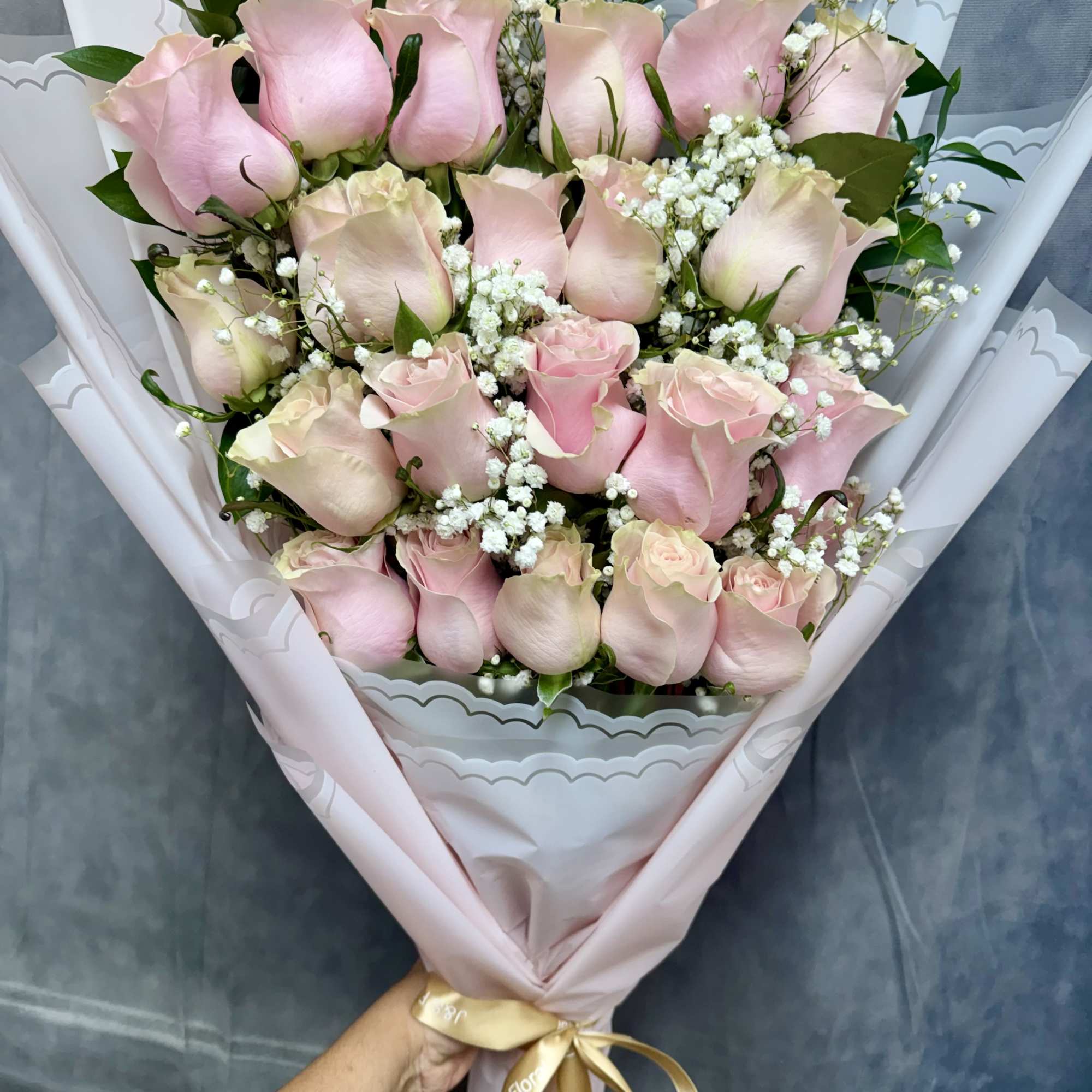 The pink roses bouquet is a charming and elegant floral arrangement featuring