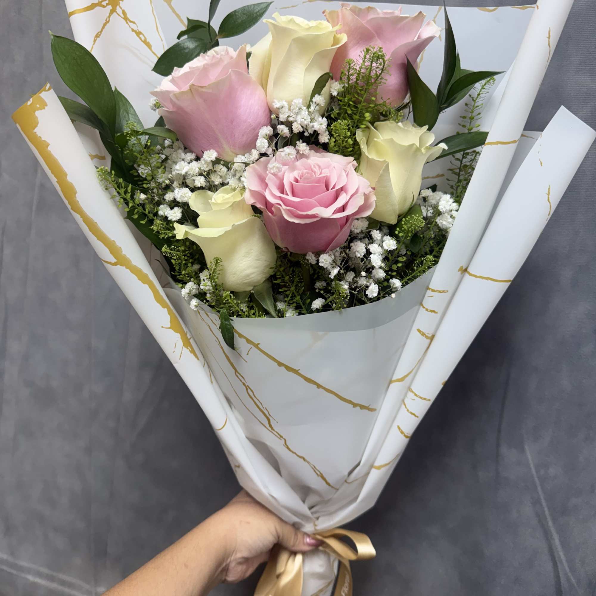 Half dozen layered Pink and white roses with baby&rsquo;s breath wrapped in