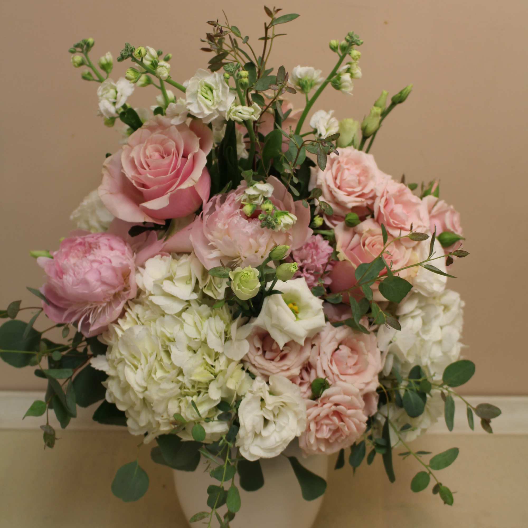 Soft hues fill this beautiful white enamel pitcher.  Hydrangea, peonies, roses