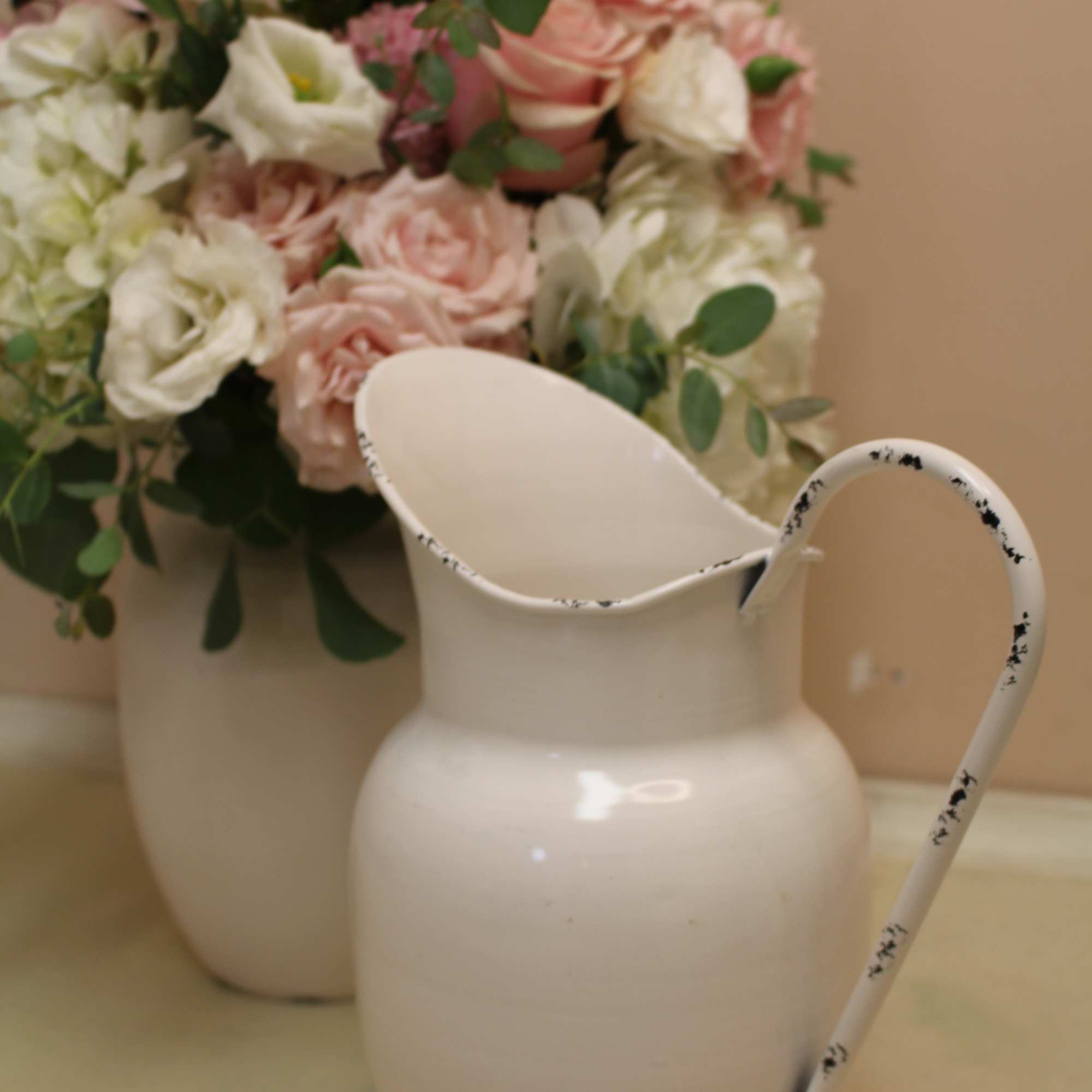 Soft hues fill this beautiful white enamel pitcher.  Hydrangea, peonies, roses