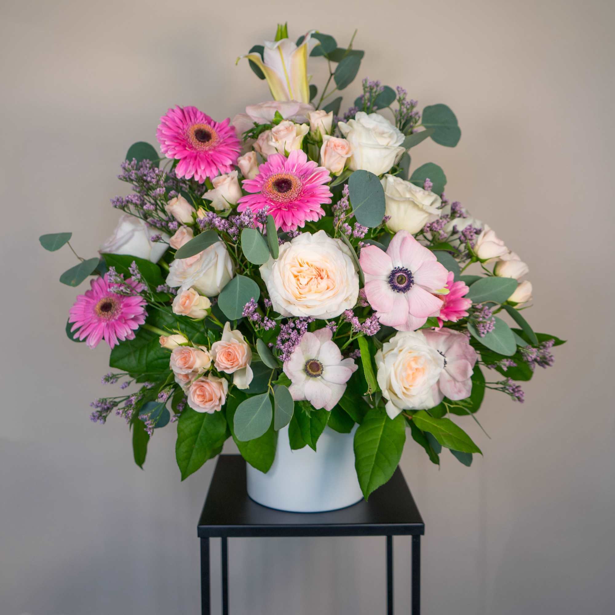 Pink and white flower arrangement in a white vase