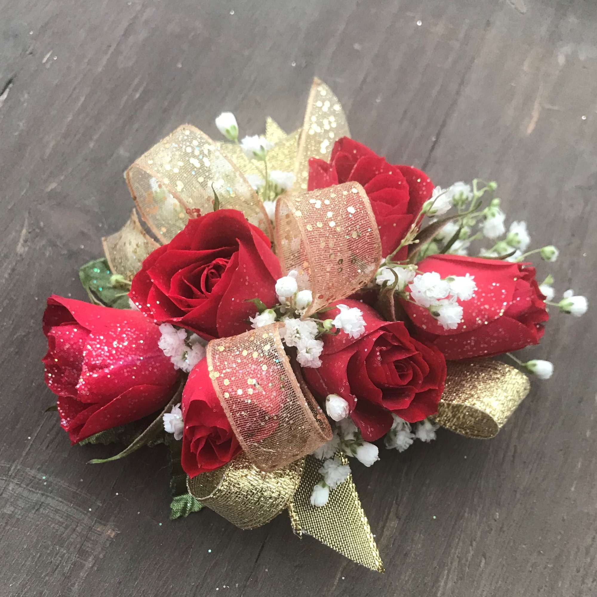 Red Spray Roses with gold accents designed on wrist band.