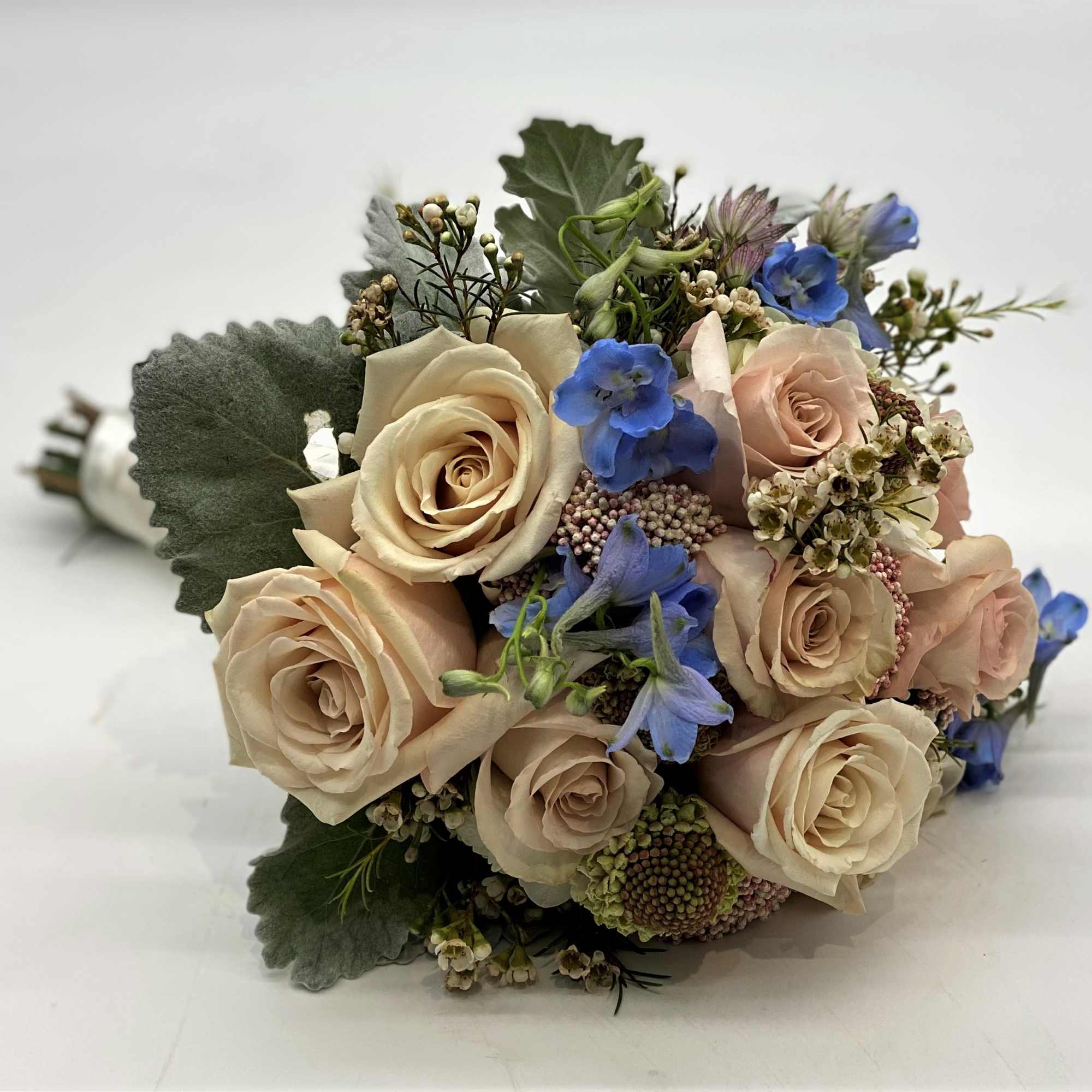 The dusty coloring of this bouquet with the touch of pale blue